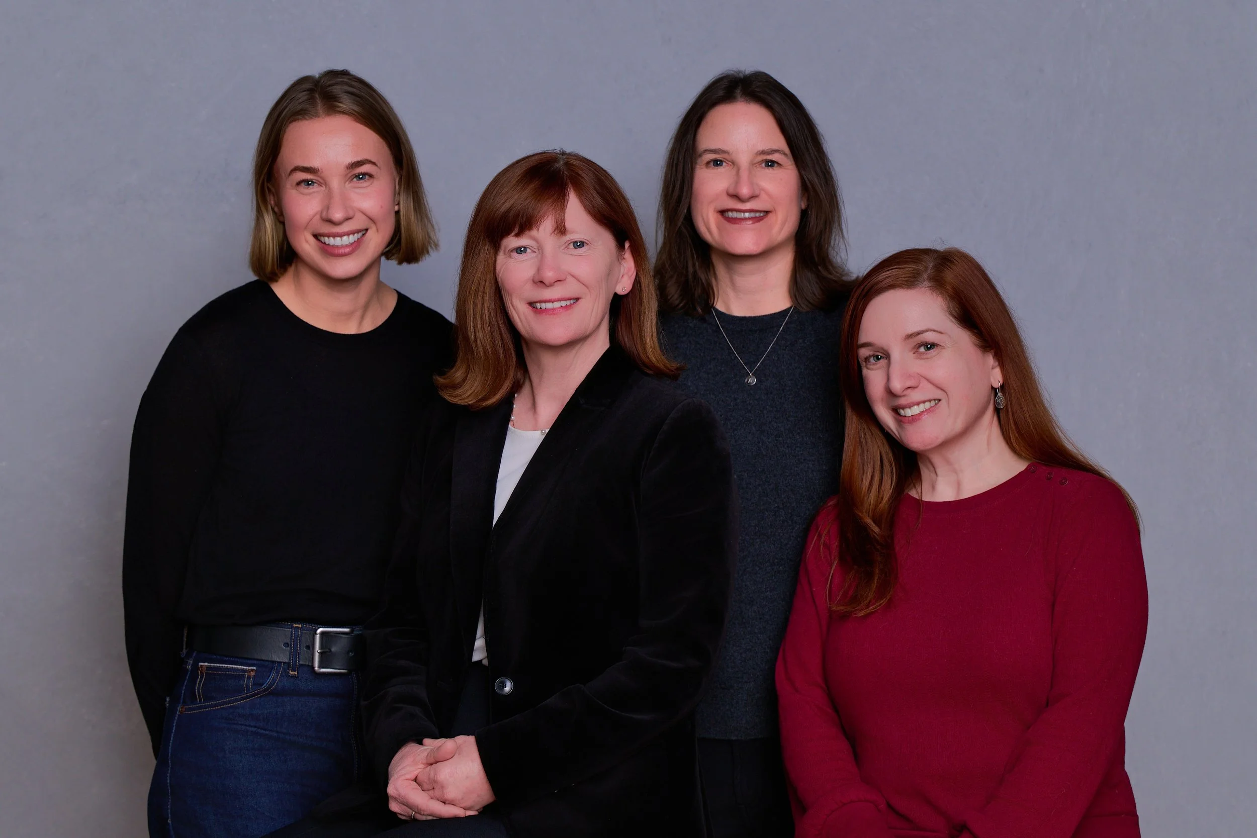 Four members of the Tandem Workforce Collaborative team — Brit, Donna, Abryana, and Melissa — smiling together in a group portrait against a neutral gray background.