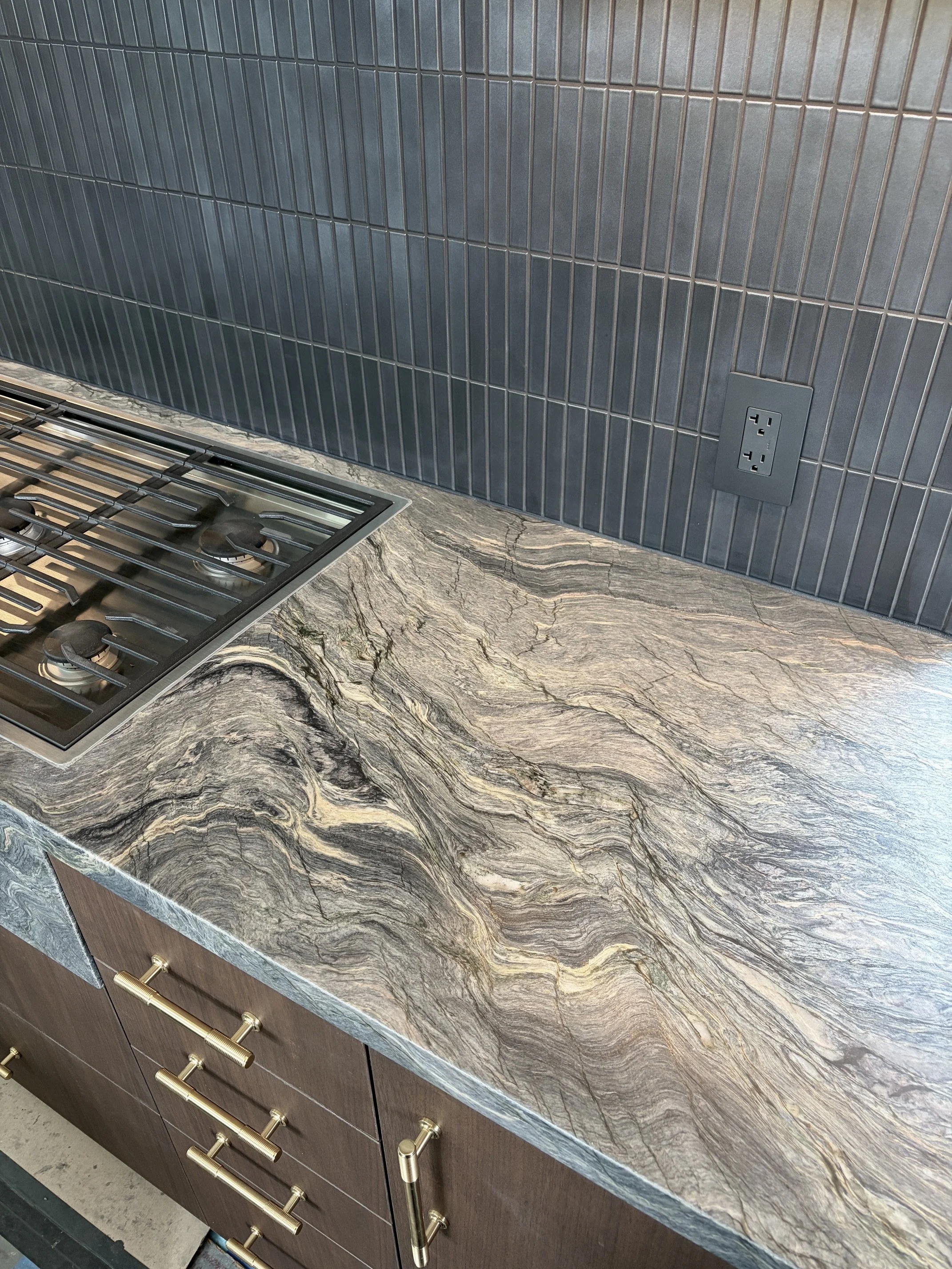 Detail view of backsplash tile and quartzite counters