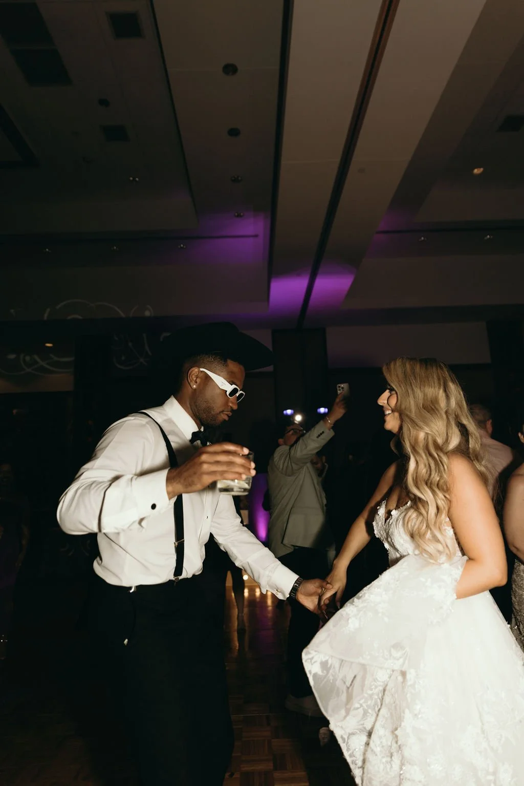 Bride, groom and guests dancing together at a Latino wedding reception in Chicago