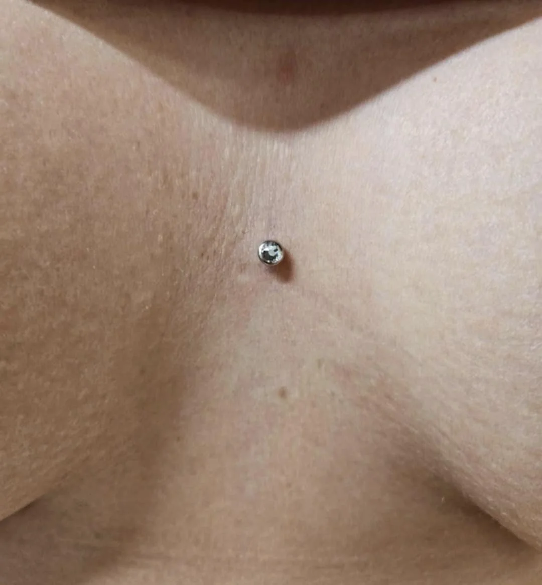 Dermal piercing on human skin
