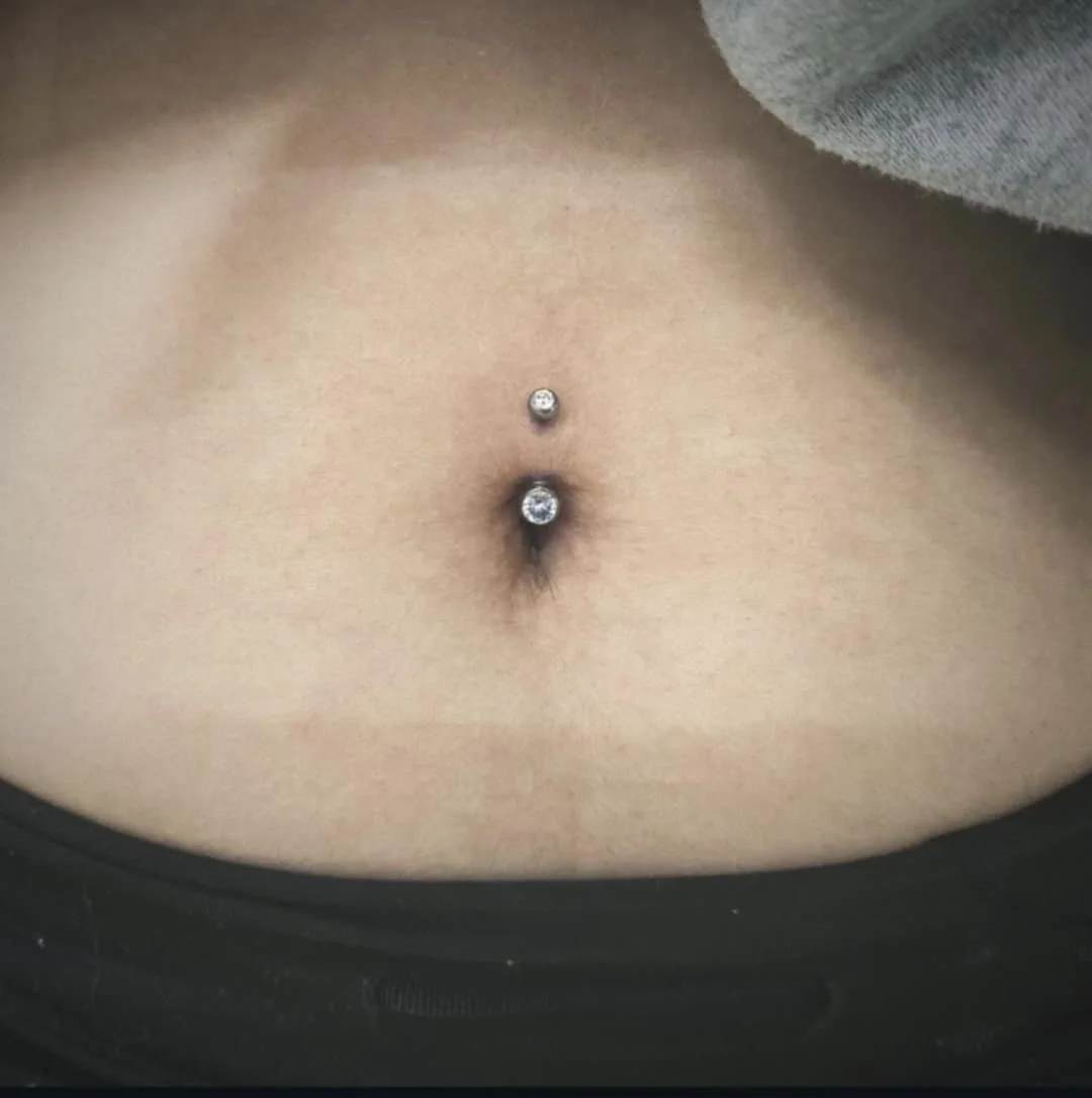 Belly button with two piercings