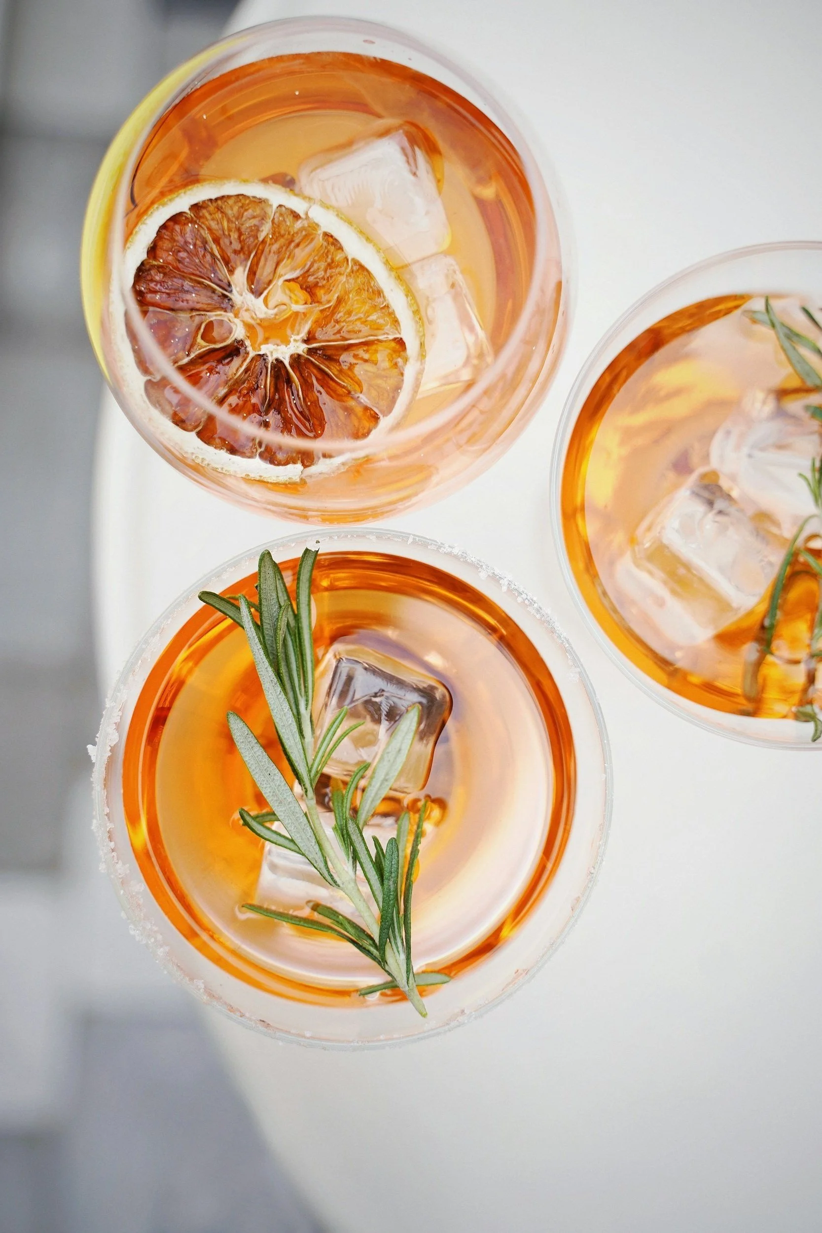 Three orange cocktails seen from above