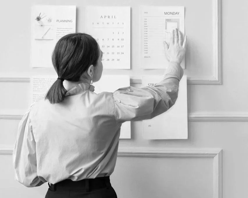 womanpinningplanneronthewall