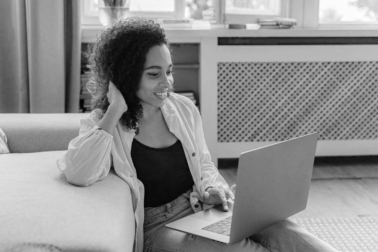 woman sitting with a coffee and laptop mariachristie