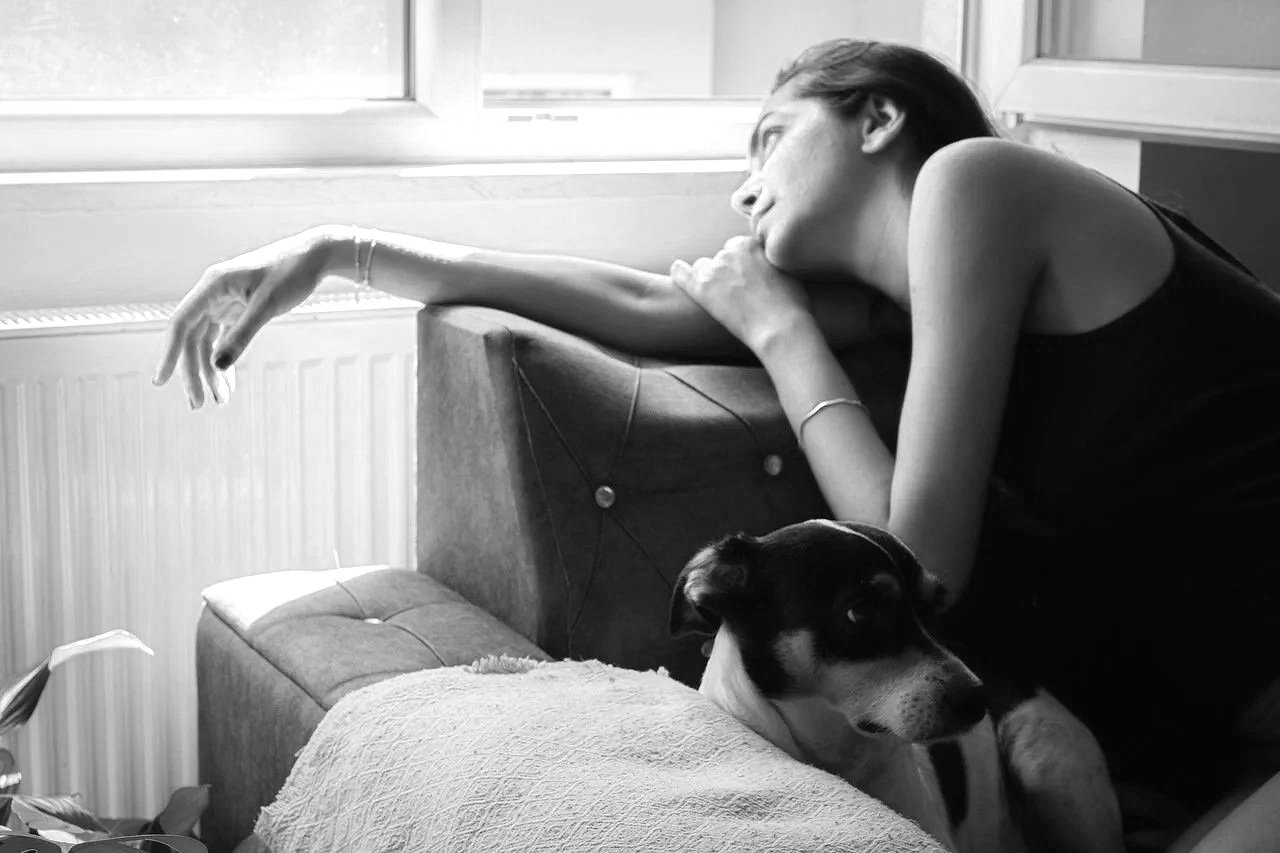 womanrecliningonhersofalookingoutofthewindow
