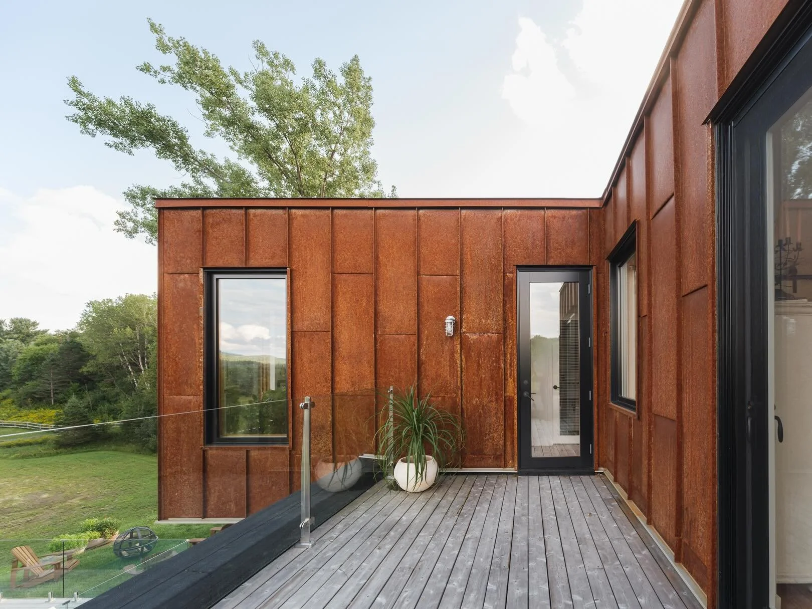 Terre et Lumi&egrave;re | Quebec | The Acre | A ranch on the outskirts of Mont-Tremblant that was designed to feel part of the hillside, not impose on it. Acre Architects chose 22ga Ironbound weathering steel standing seam to let the building age int
