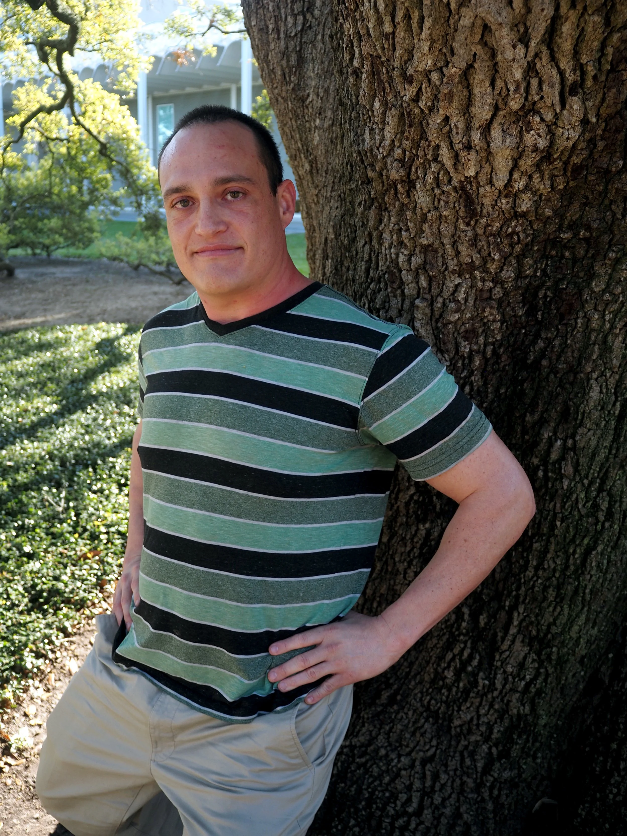 Cay leaning against tree