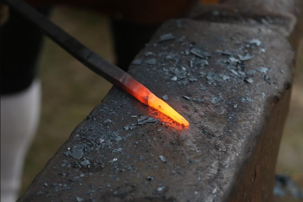 Glowing red-hot iron on an anvil, symbolizing the steel metaphor for a twice exceptional adult