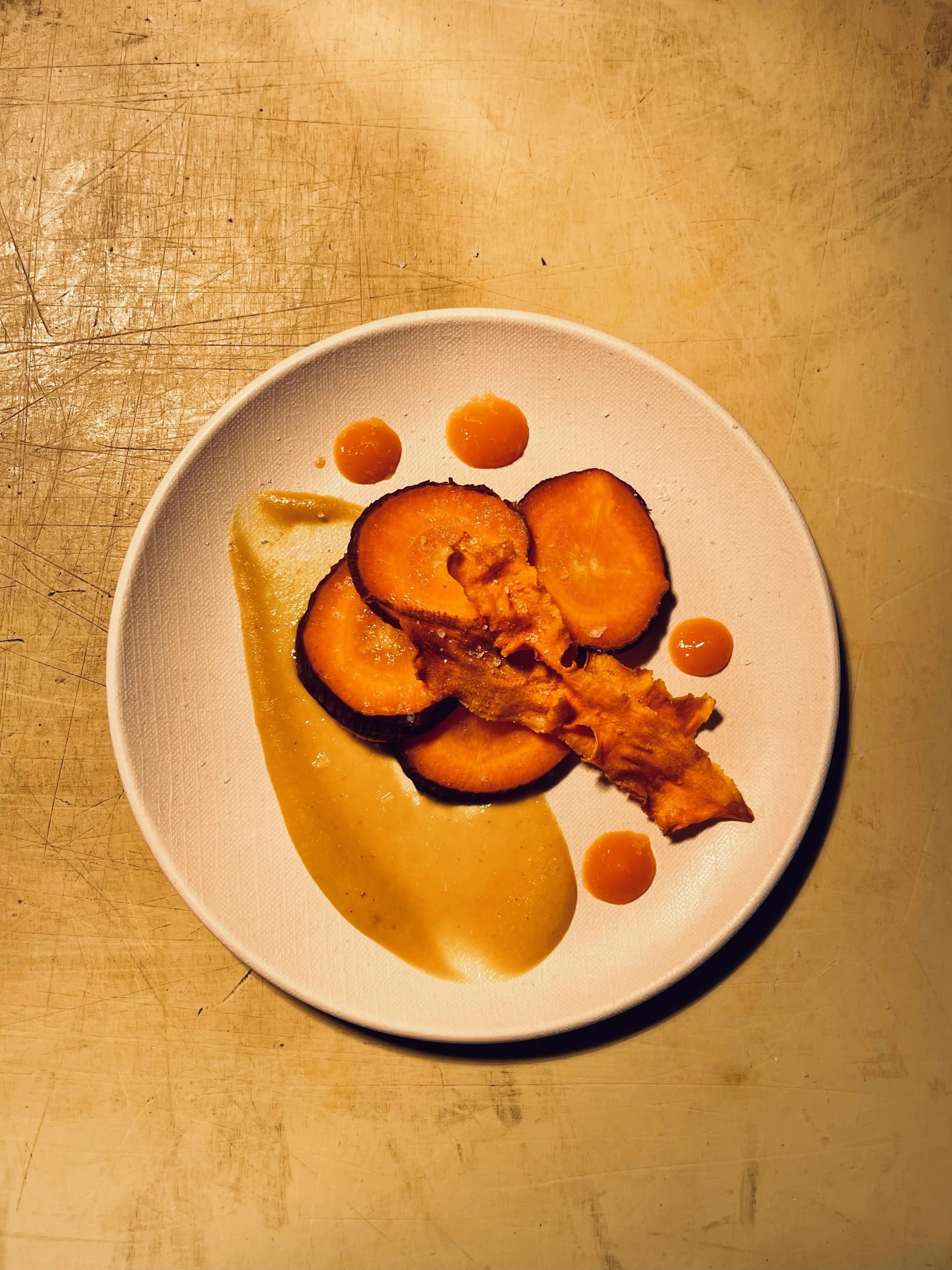 Smoked Carrots with a carrot puree, carrot-lina bbq sauce, and carrot chips