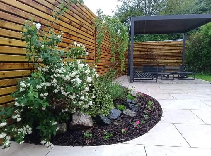Low maintenance modern garden design and installation in Haslington, Crewe with porcelain paving installation and Venetian style fencing plus pergola