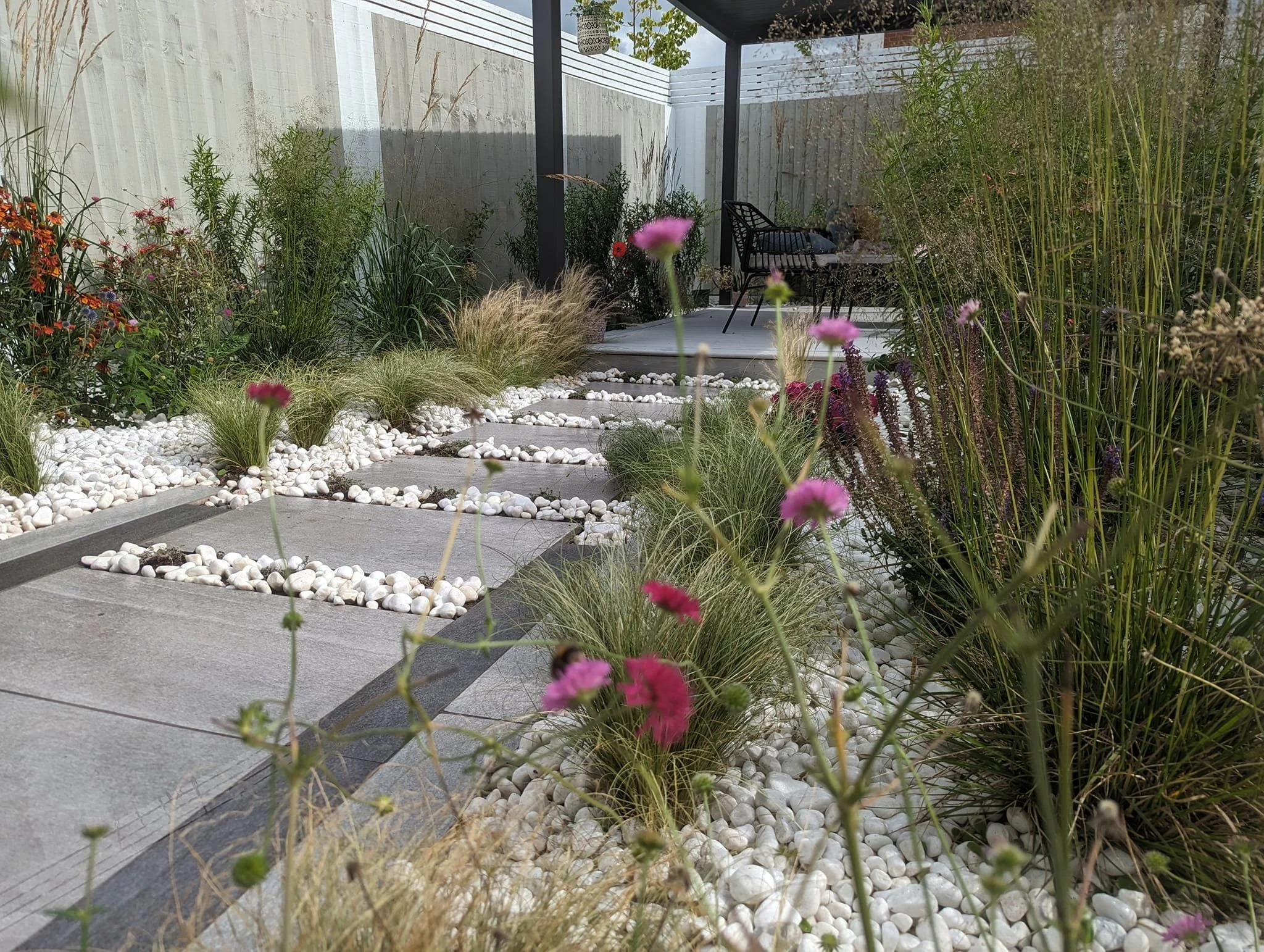 New build garden landscaping designed and built by Goodwin Gardens Ltd in Trentham, Stoke-on-Trent. With pergola, fencing, planting and porcelain paving