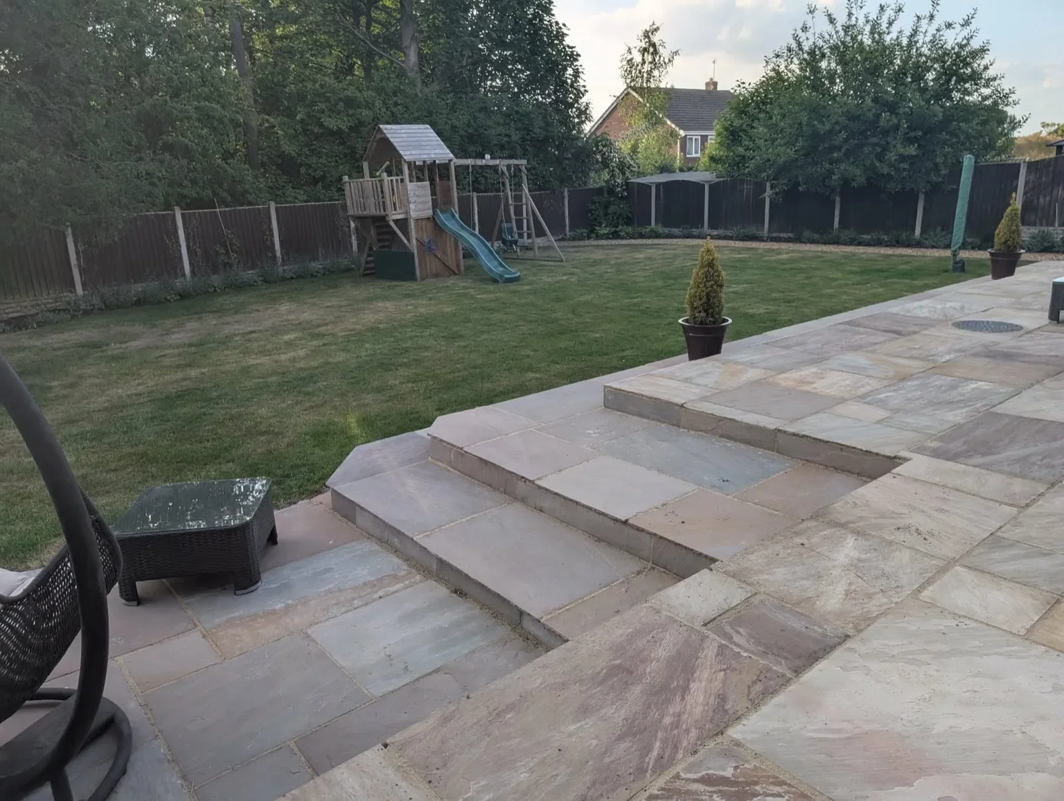 Indian sandstone patio installation in Sandbach with wrap around steps and low maintenance planting