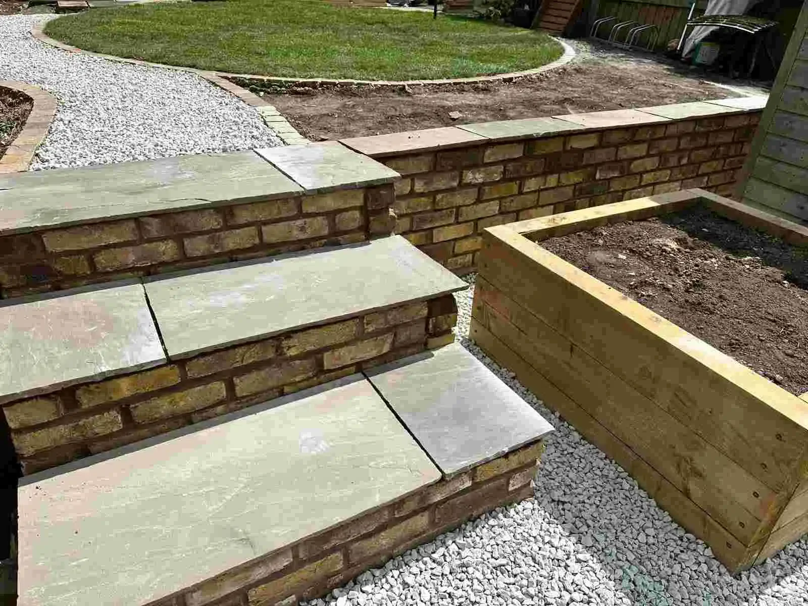 Indian sandstone paving combined with reclaimed brickwork within a full garden makeover in Crewe