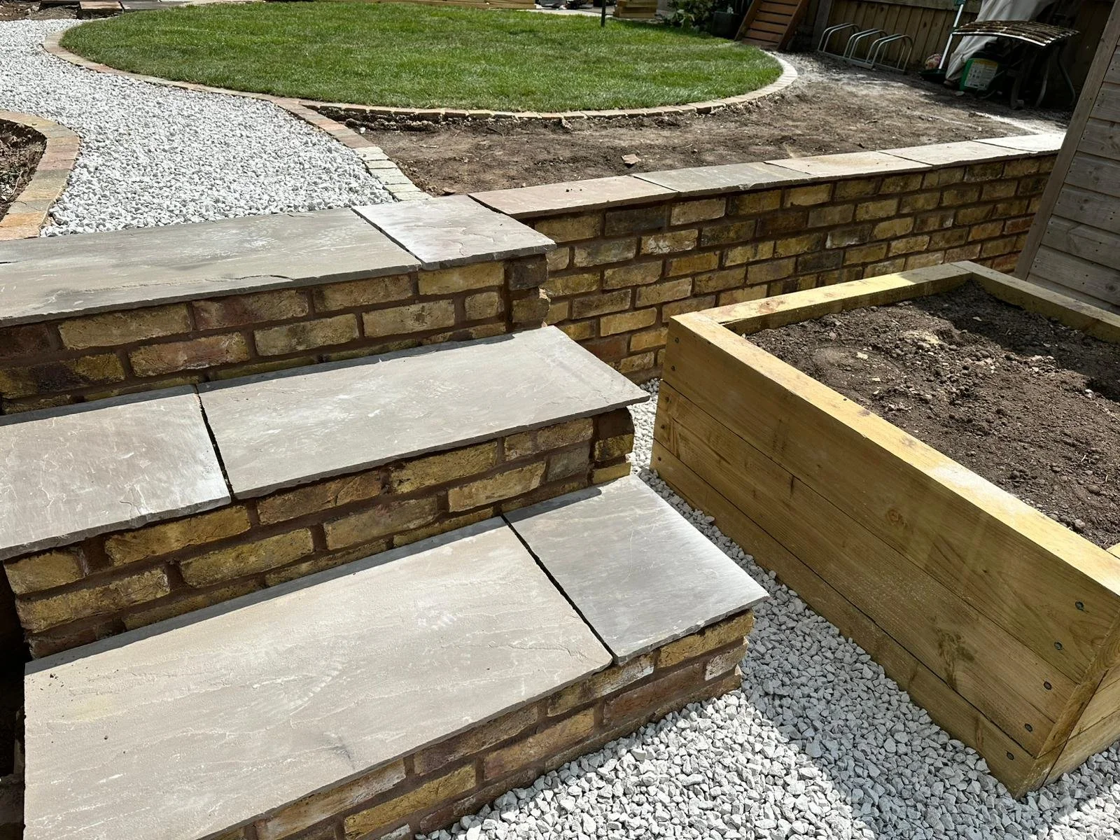 Full garden design and installation in Crewe with reclaimed brickwork, Indian sandstone paving plus raised beds and new lawn turfing
