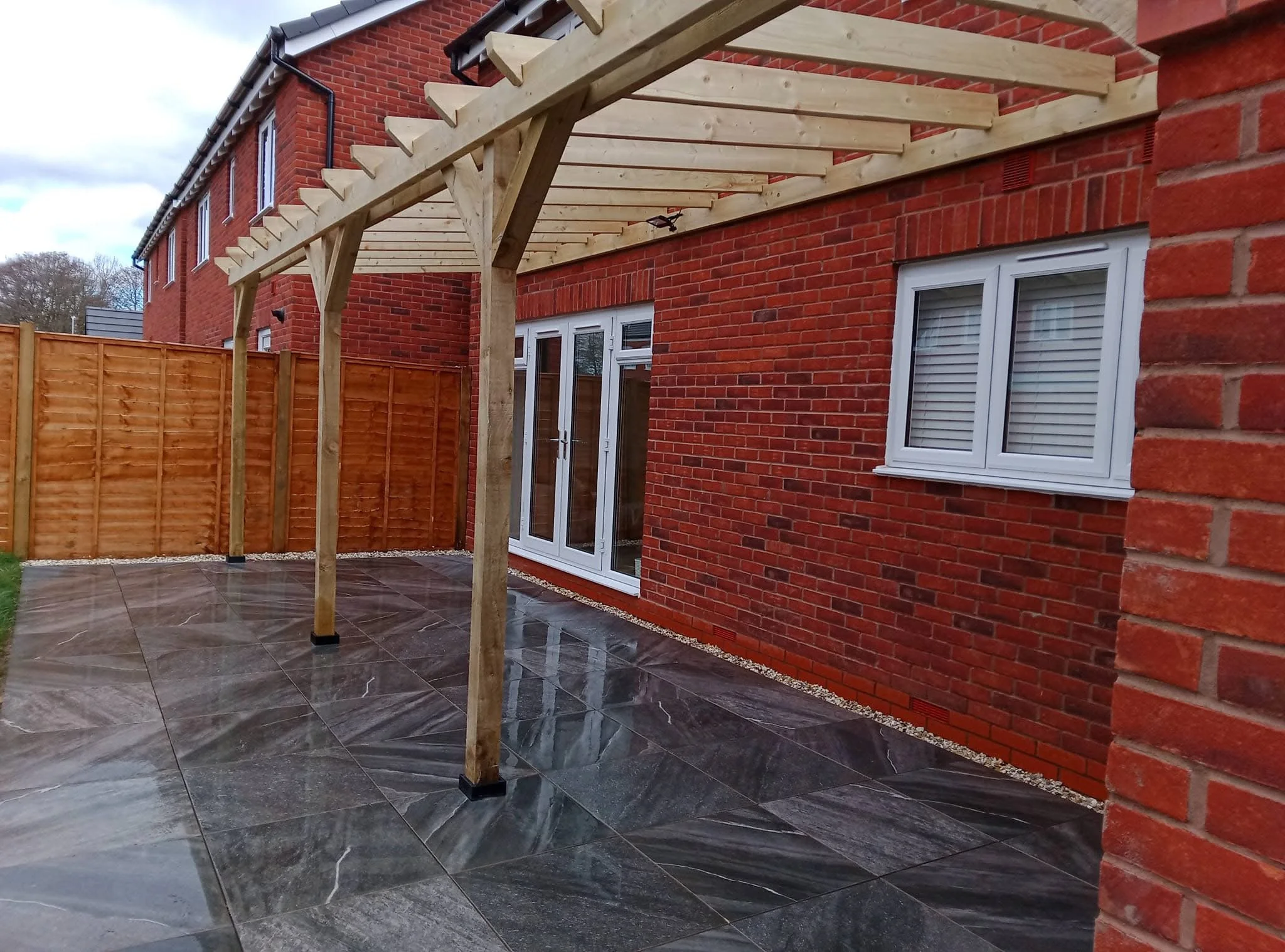 Porcelain patio installation with lean-to pergola construction in Haslington, Crewe