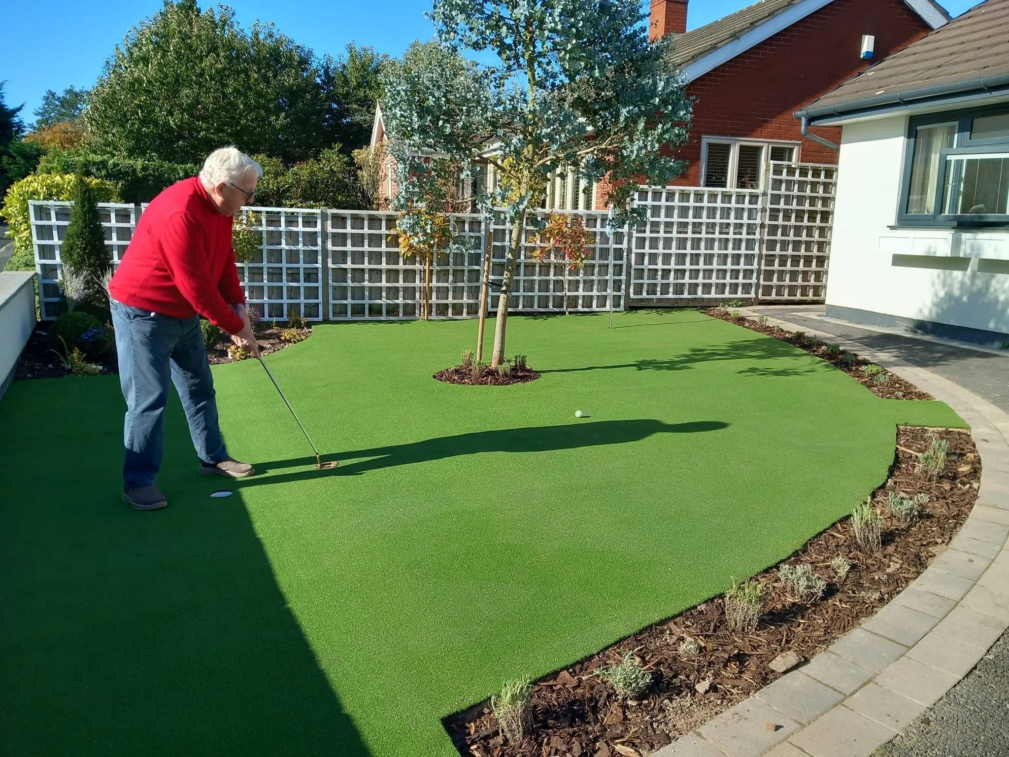 Artificial grass putting green with lavender hedge installed near Nantwich
