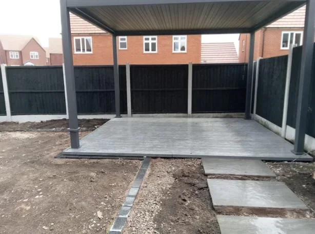 Composite decking installed with aluminium pergola during a new build garden landscaping project on broad meadow park in Sandbach