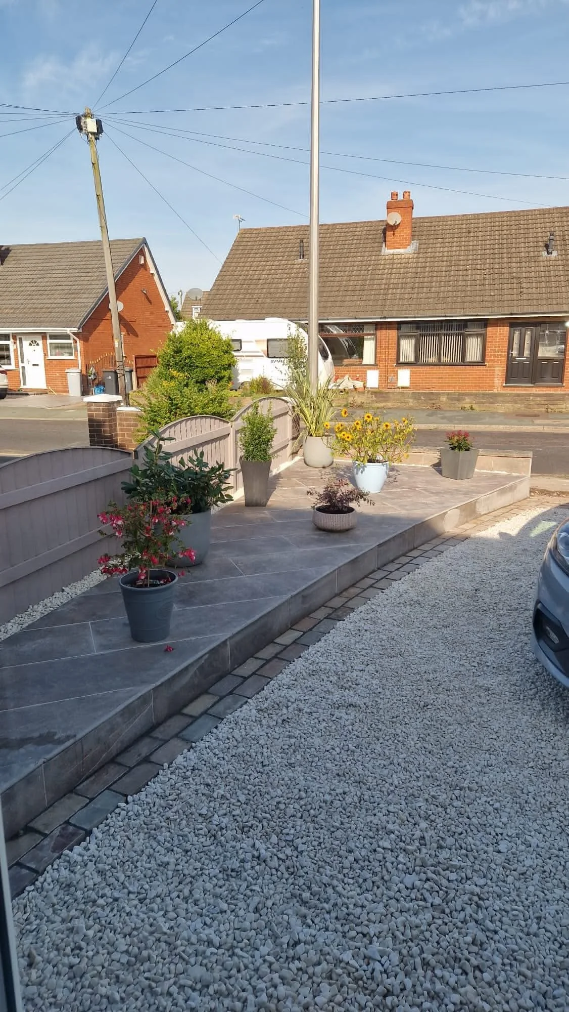 Front garden makeover in Haslington, Crewe with bespoke porcelain paving installation and gravel driveway