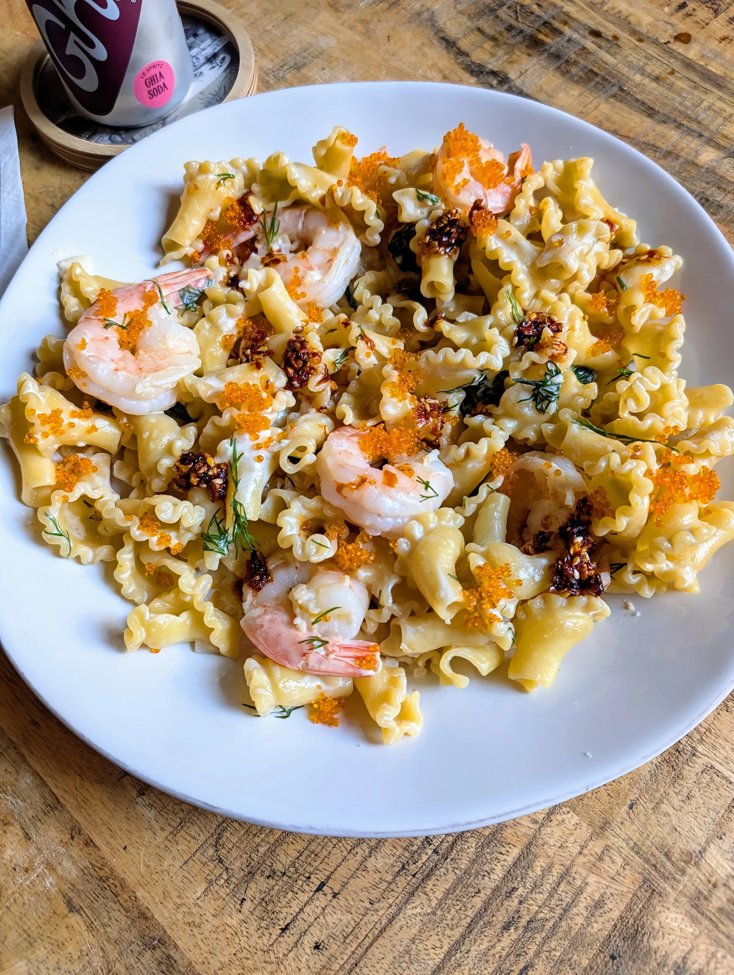 Plate of shrimp alfredo with tobiko (fish roe) and chili crisp