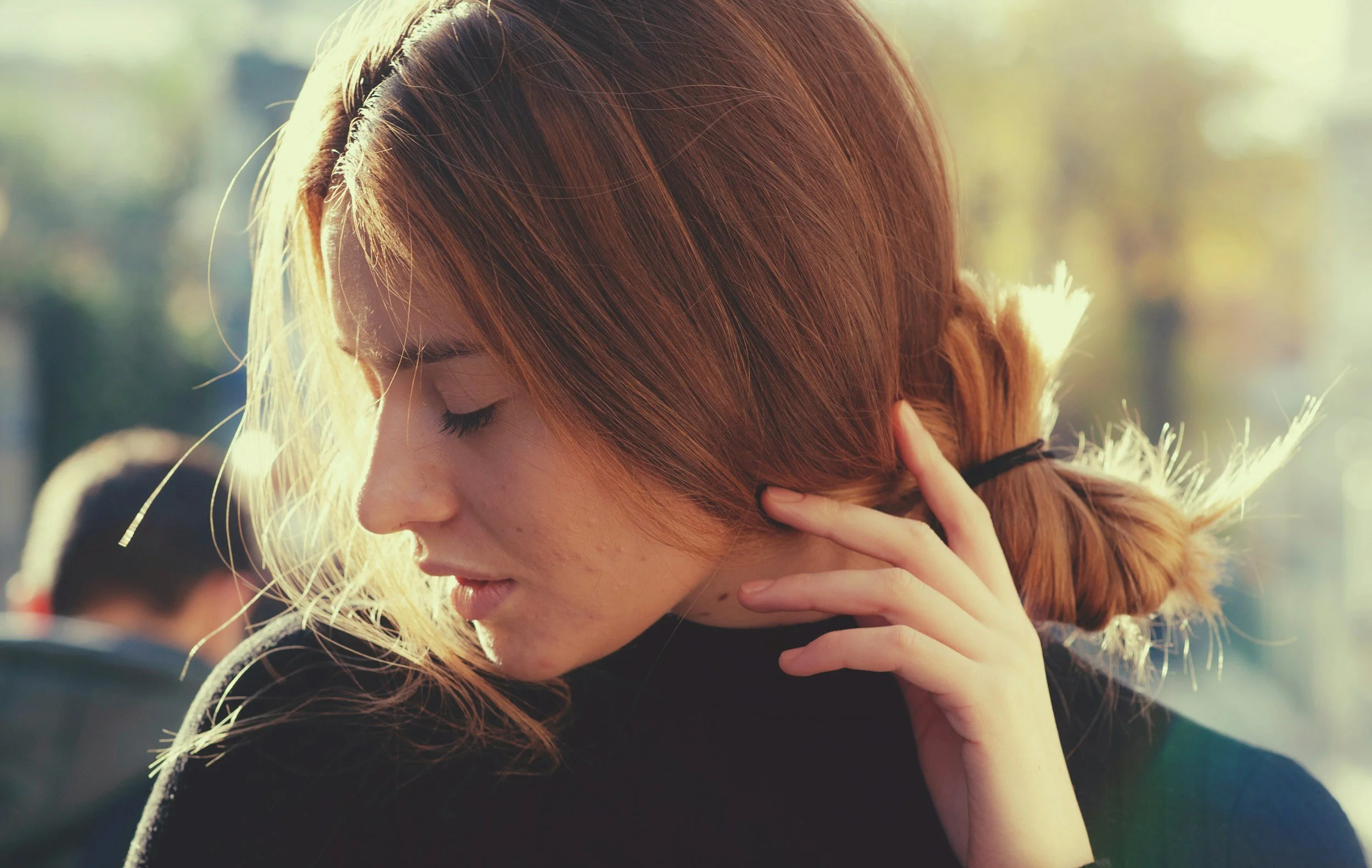 girl with eyes closed head tilted down