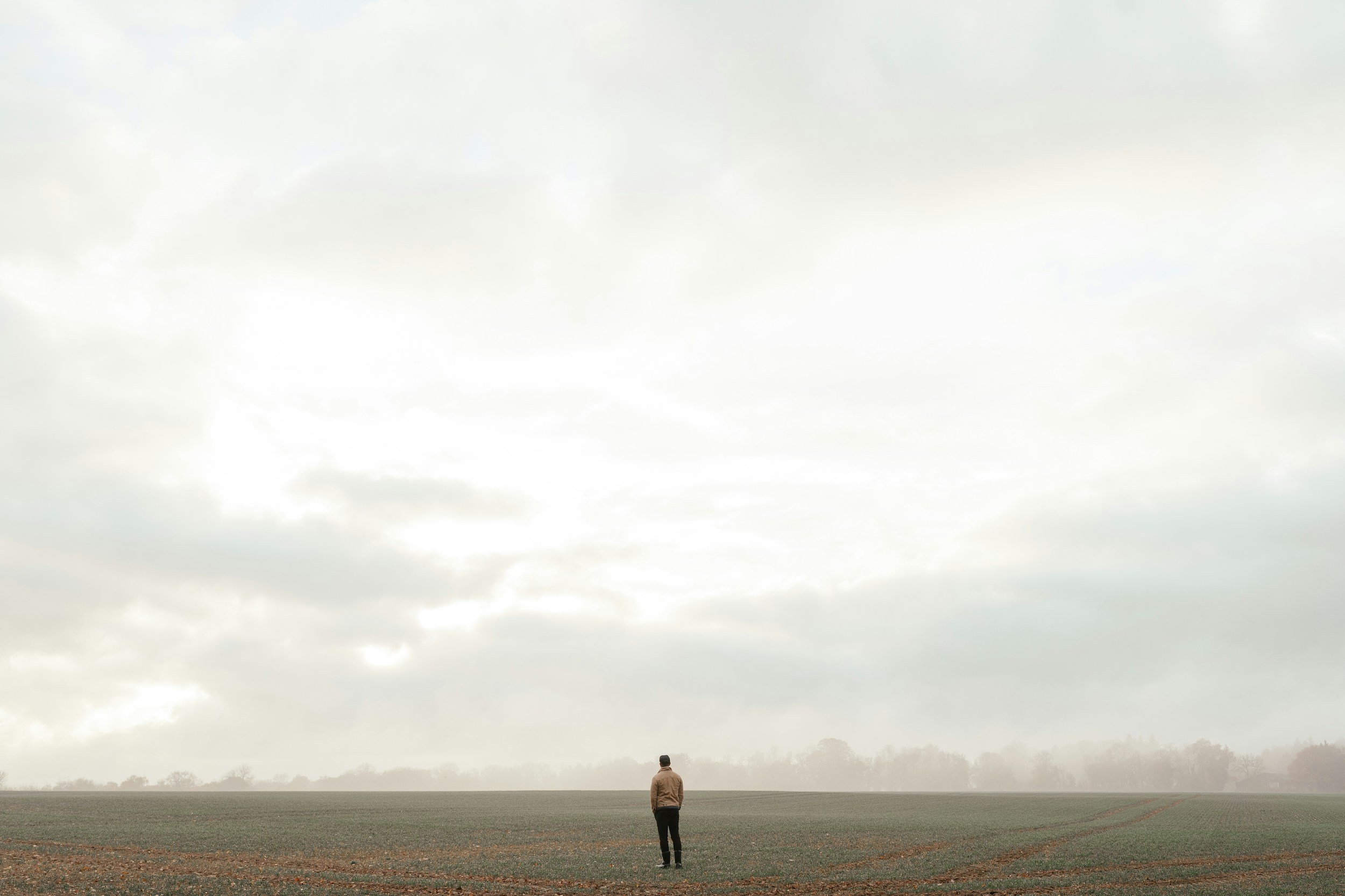 person standing alone in big field