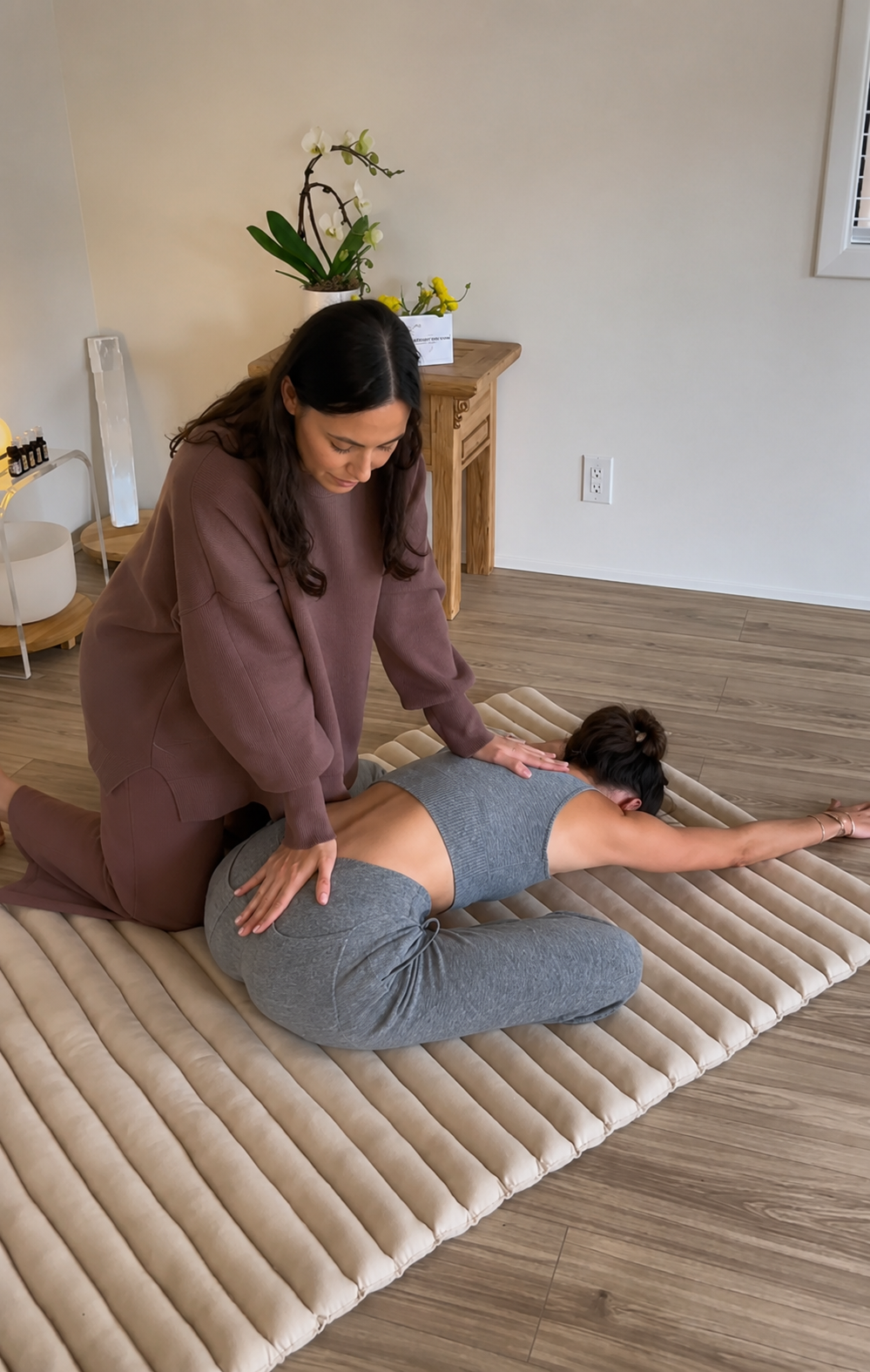 Practitioner providing hands-on guidance during an assisted stretching session in Malibu.
