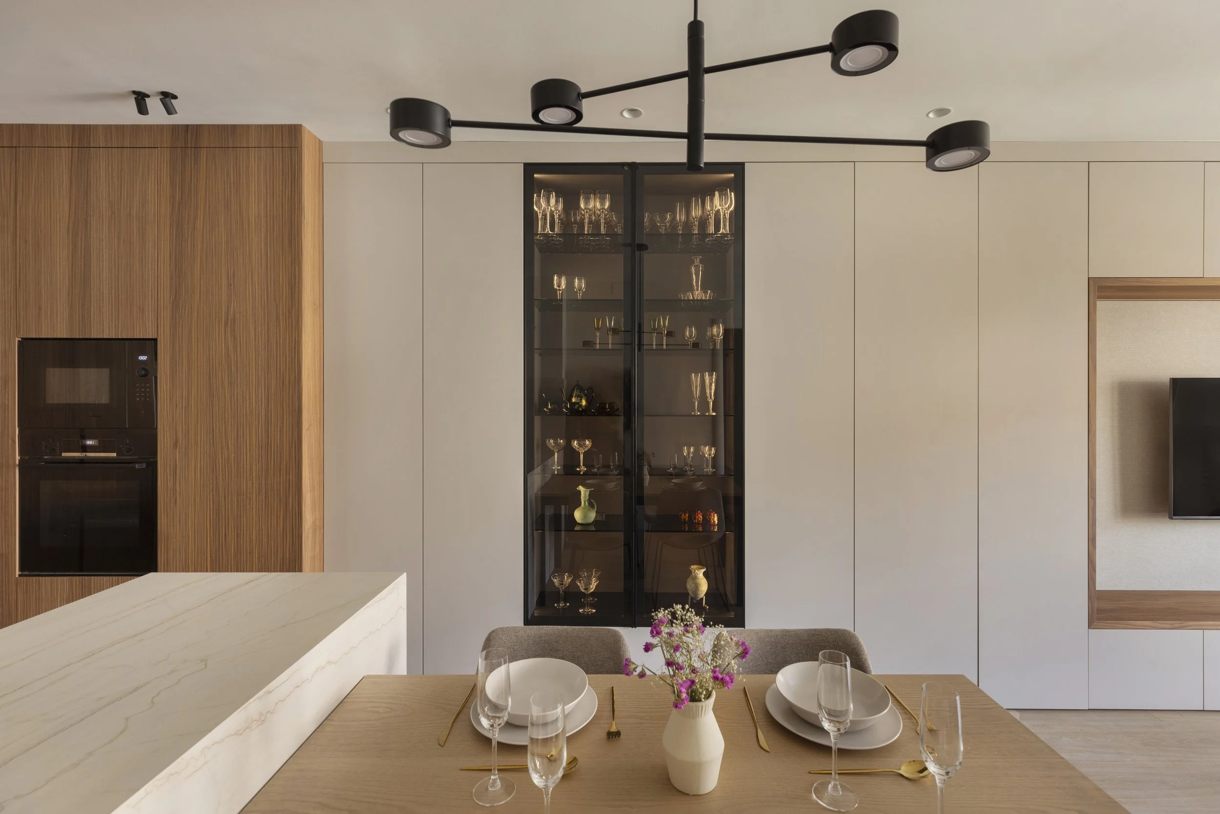Close-up of American walnut cabinetry and hidden storage solutions designed by Alba Roca Studio for the Castillejos apartme.jpg