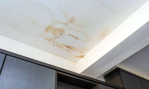 Tea-coloured water stain on ceiling indicating a roof leak