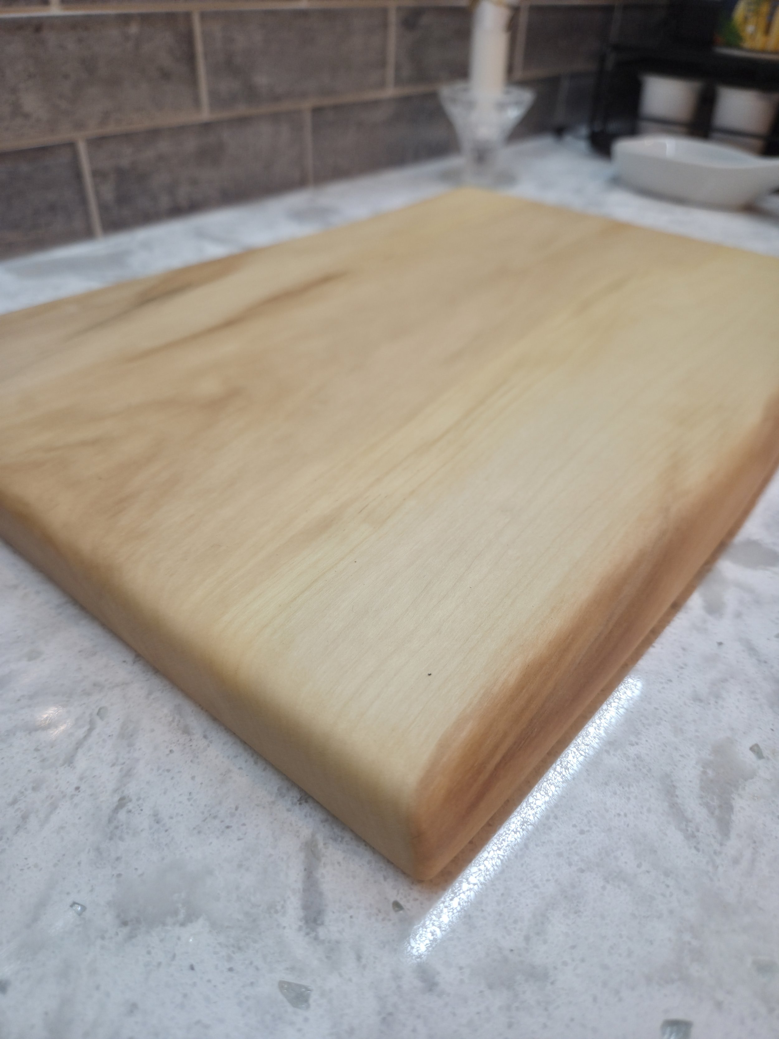 maple live edge cutting board on a counter