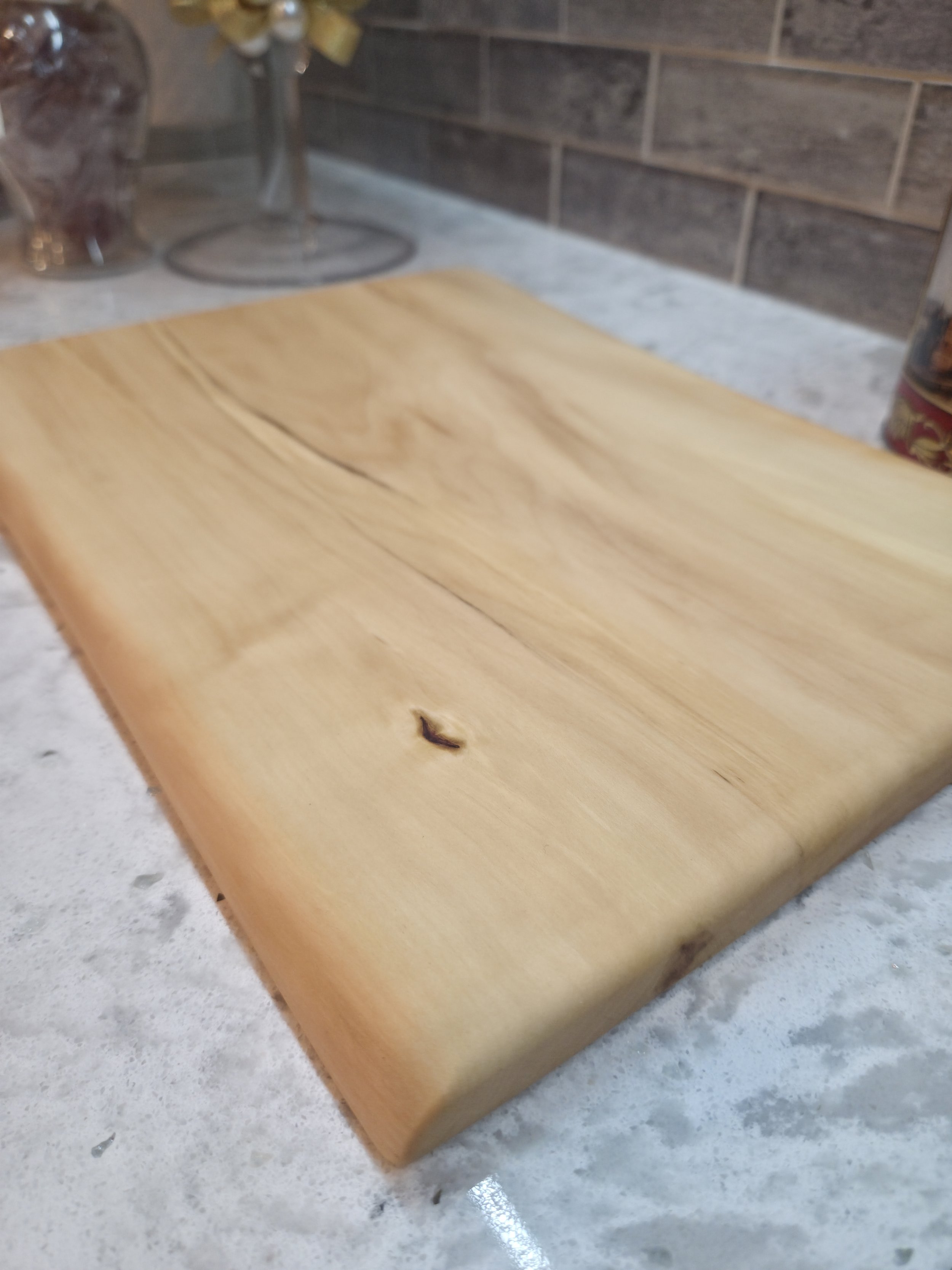 maple live edge cutting board on a counter