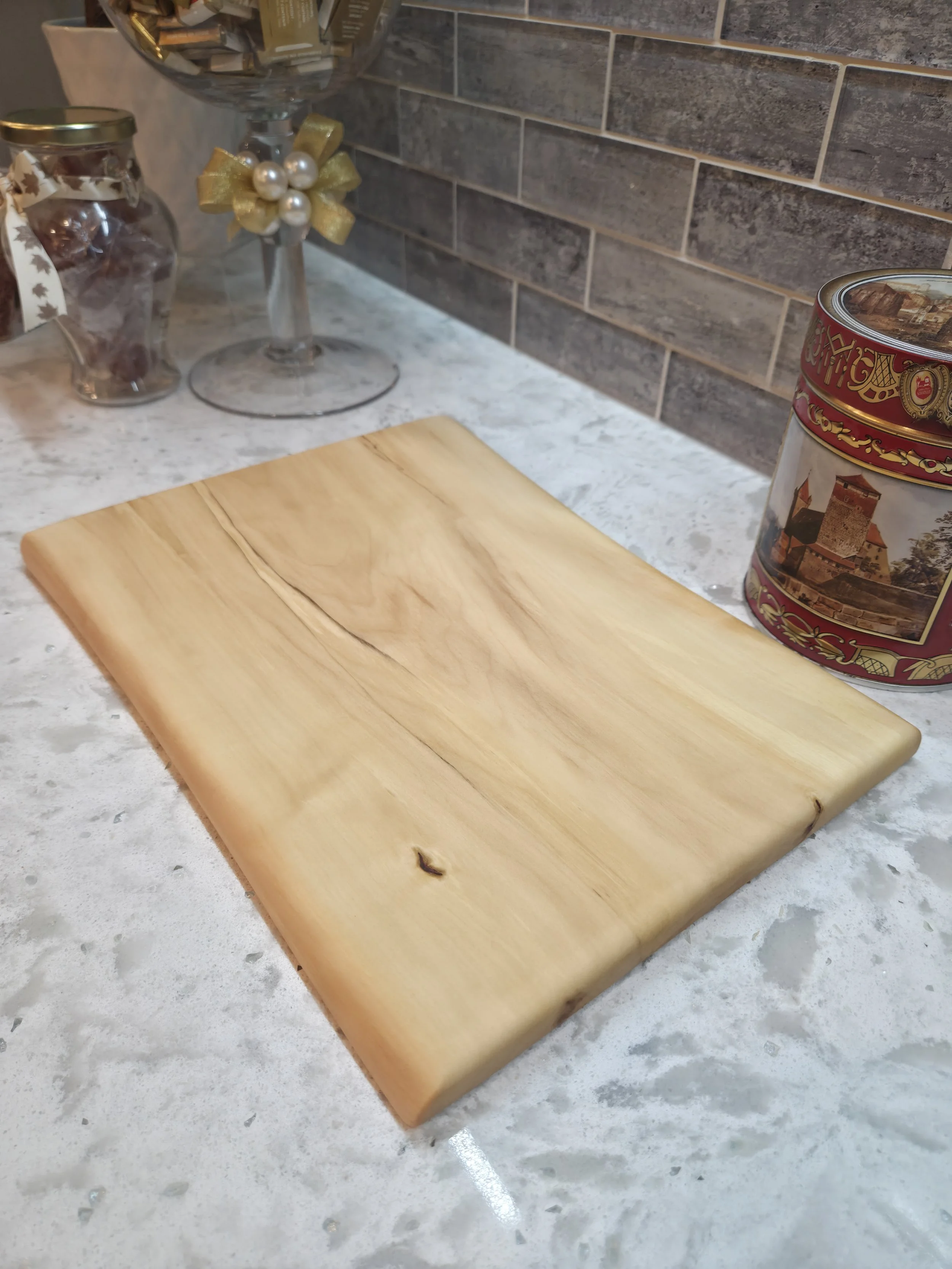 maple live edge cutting board on a counter