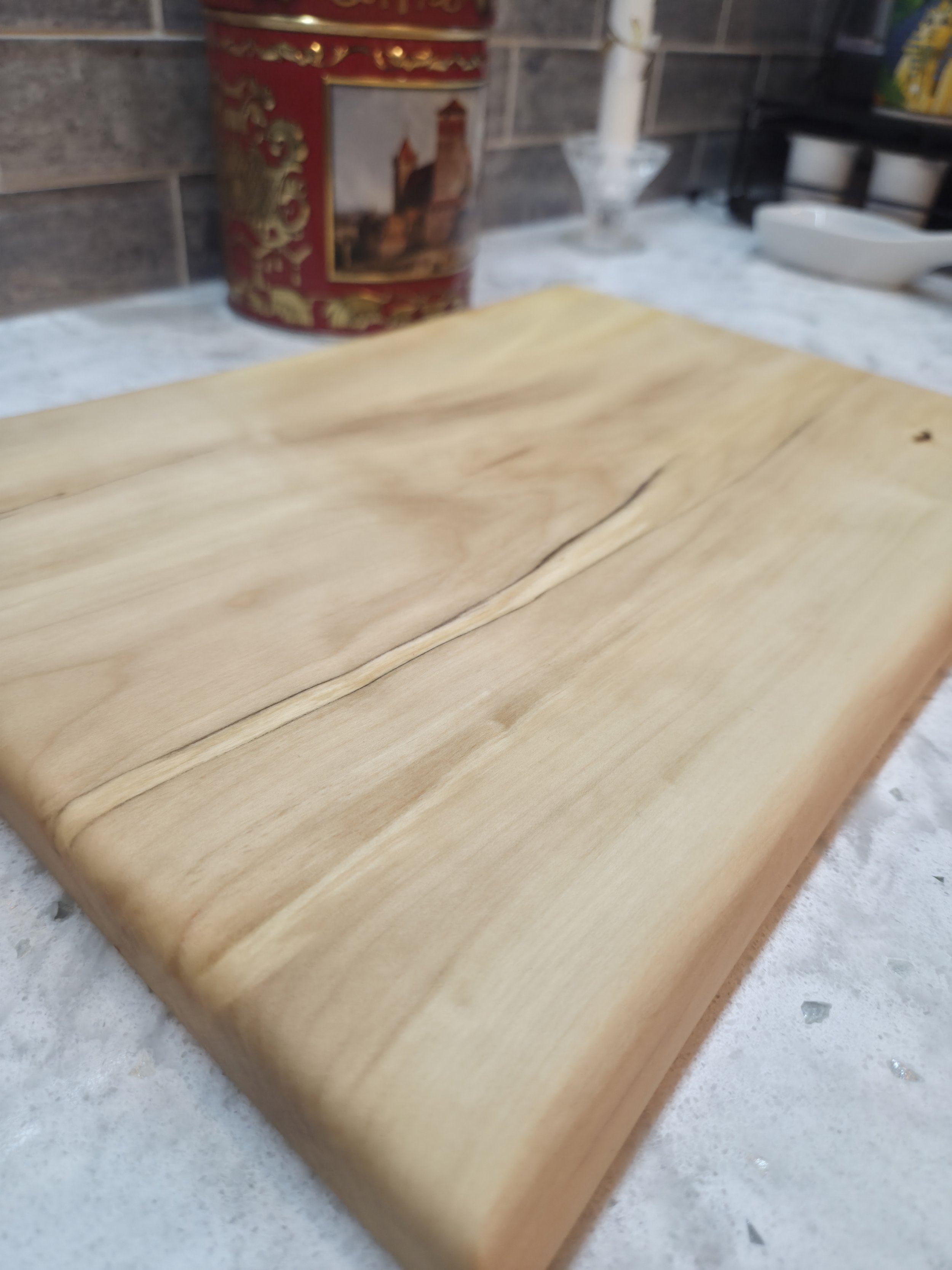 maple live edge cutting board on a counter