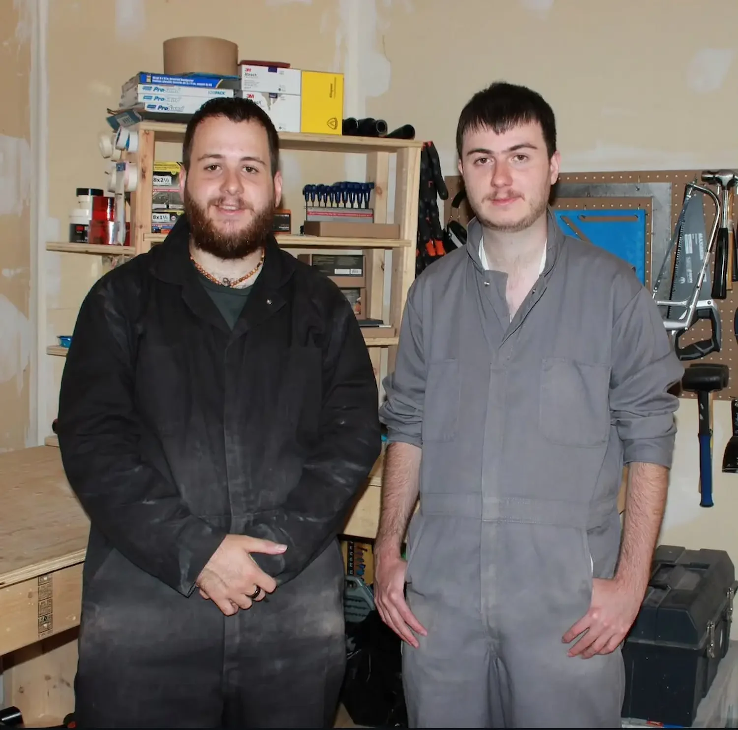 a picture of two handsome brothers wearing a woodworking apron