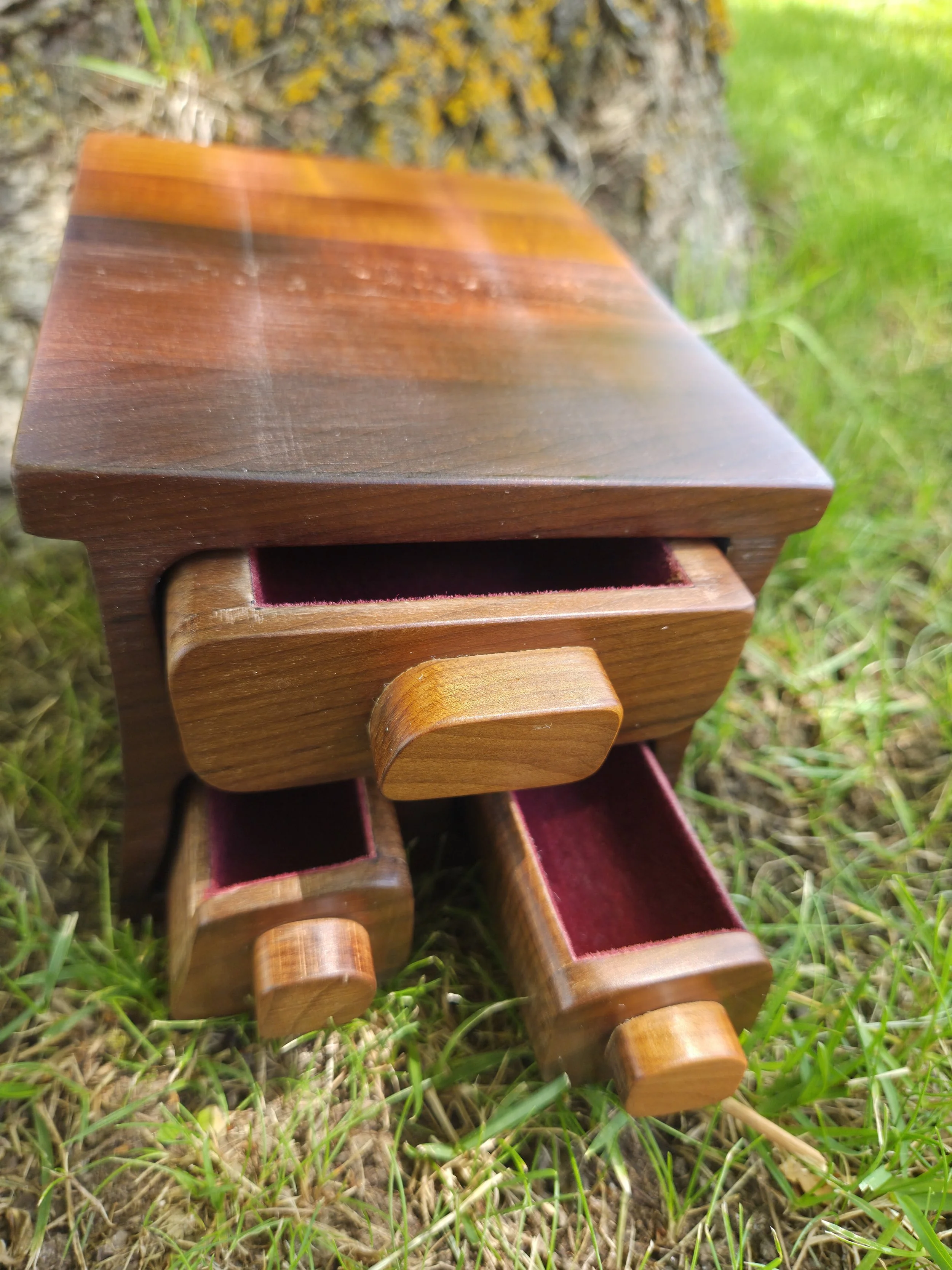 A wooden keepsake box also known as a bandsaw box with 3 drawers for small items