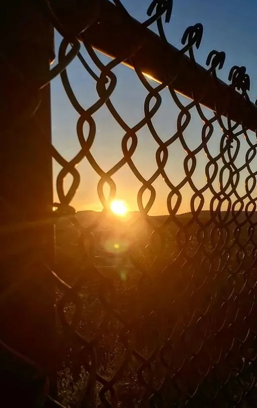sunset through chainlink fence chimney rocks hollidaysburg pa.JPG