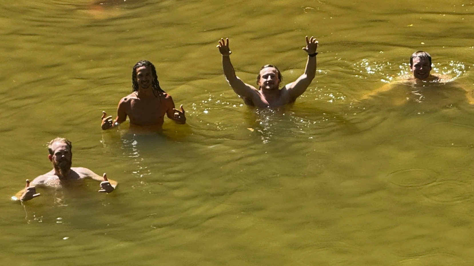 boys swimming in red river gorge after jump rock.png