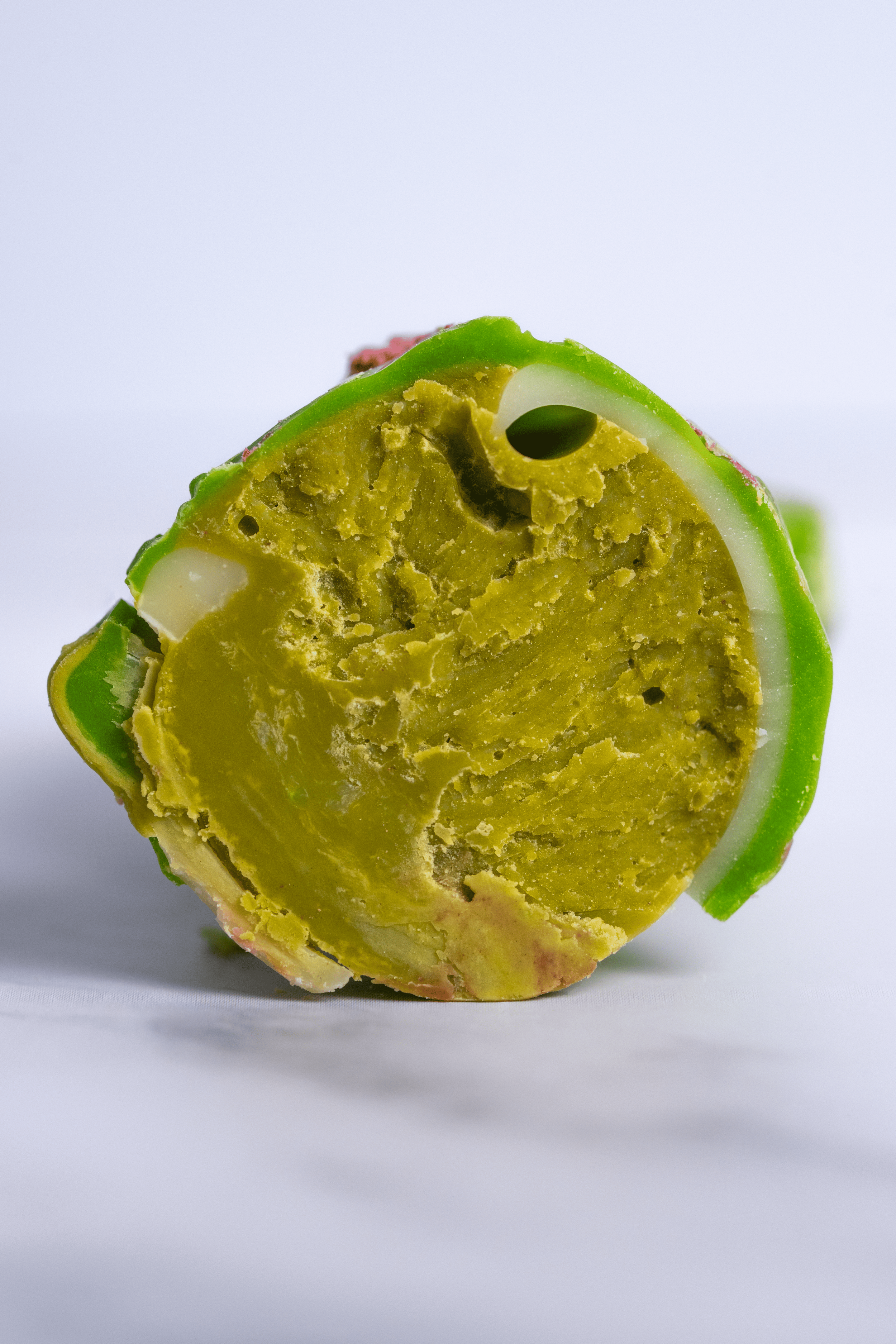 Corte transversal de la cáscara de un aguacate, mostrando la pulpa amarilla y el hueso en su interior