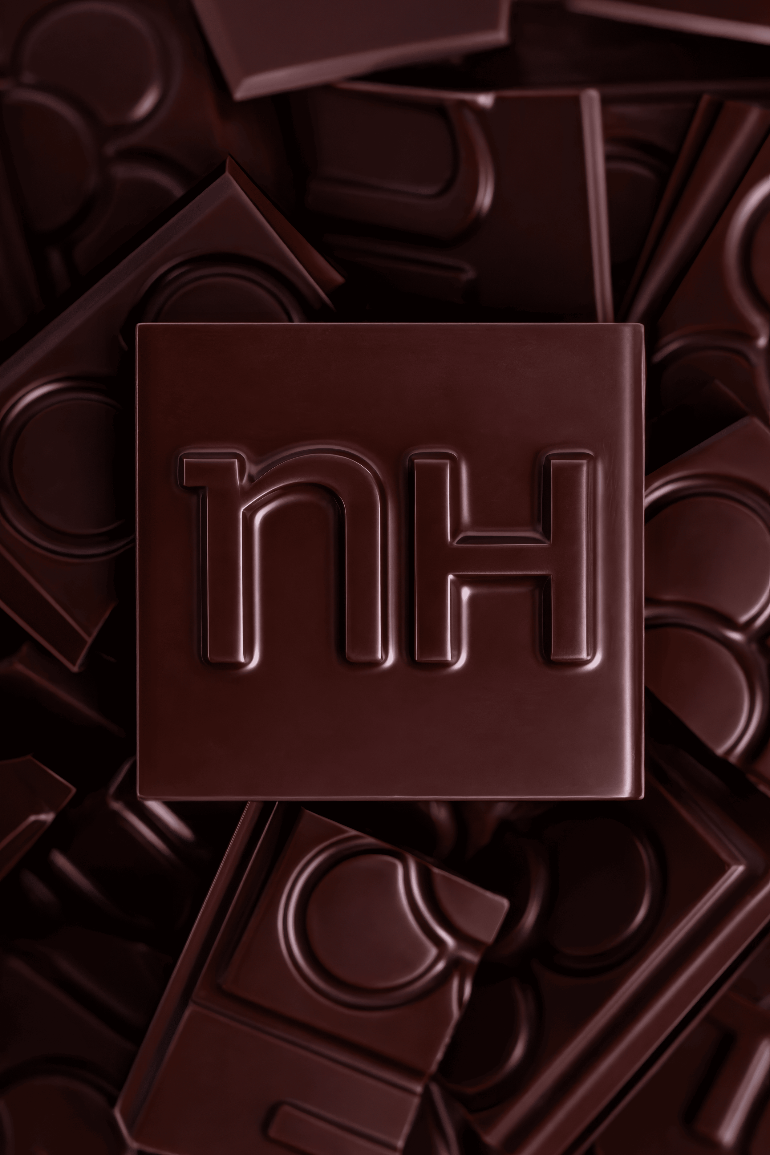 Variedad de chocolates en forma de bloques con la palabra 'HOLA' en letras grandes y en relieve en el centro.