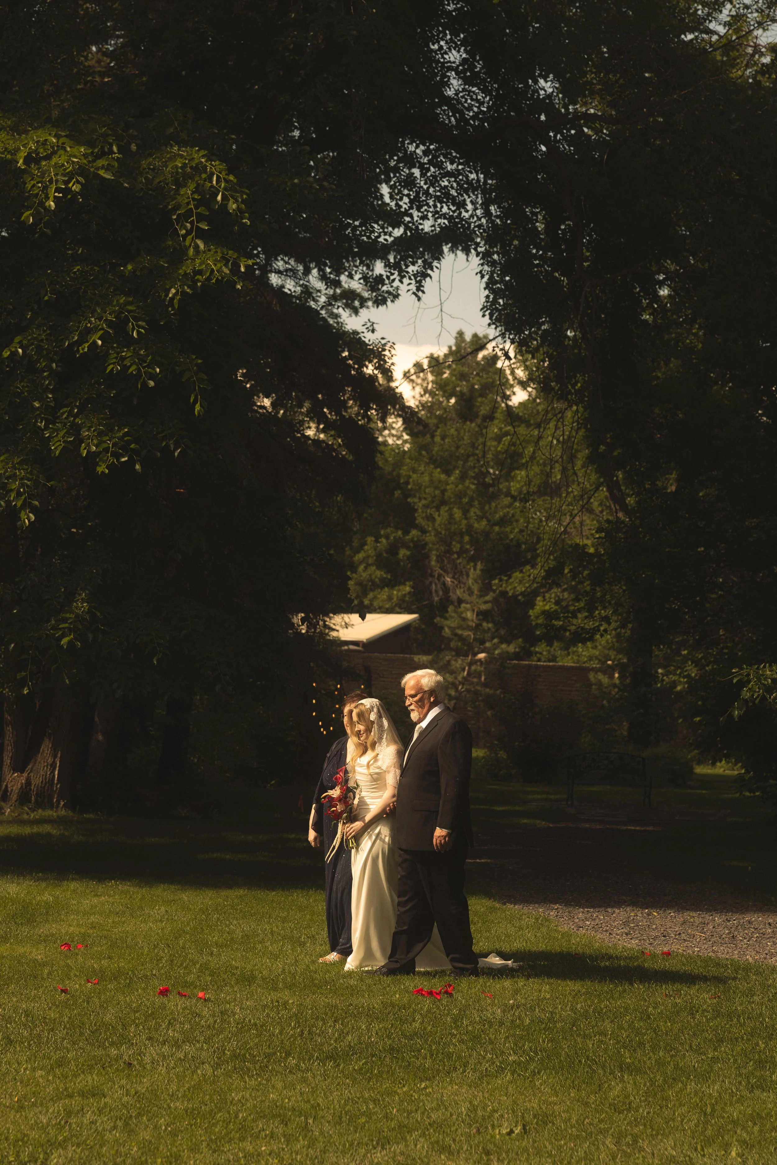 bride walking with parents at the norland historic estate 