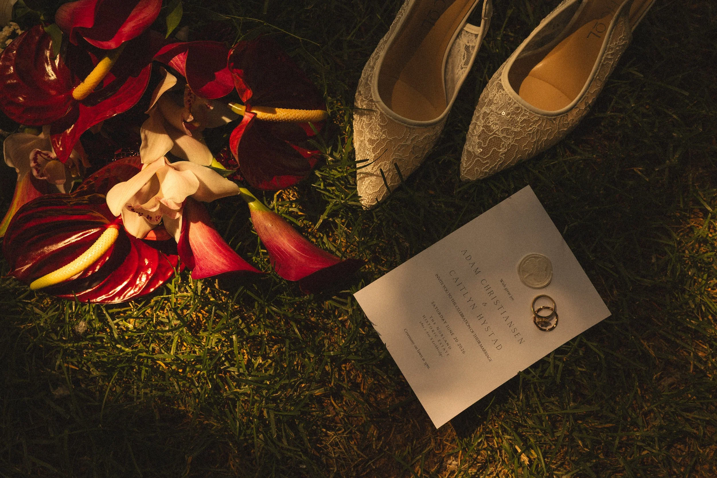 red flower with brides shoes and invitation