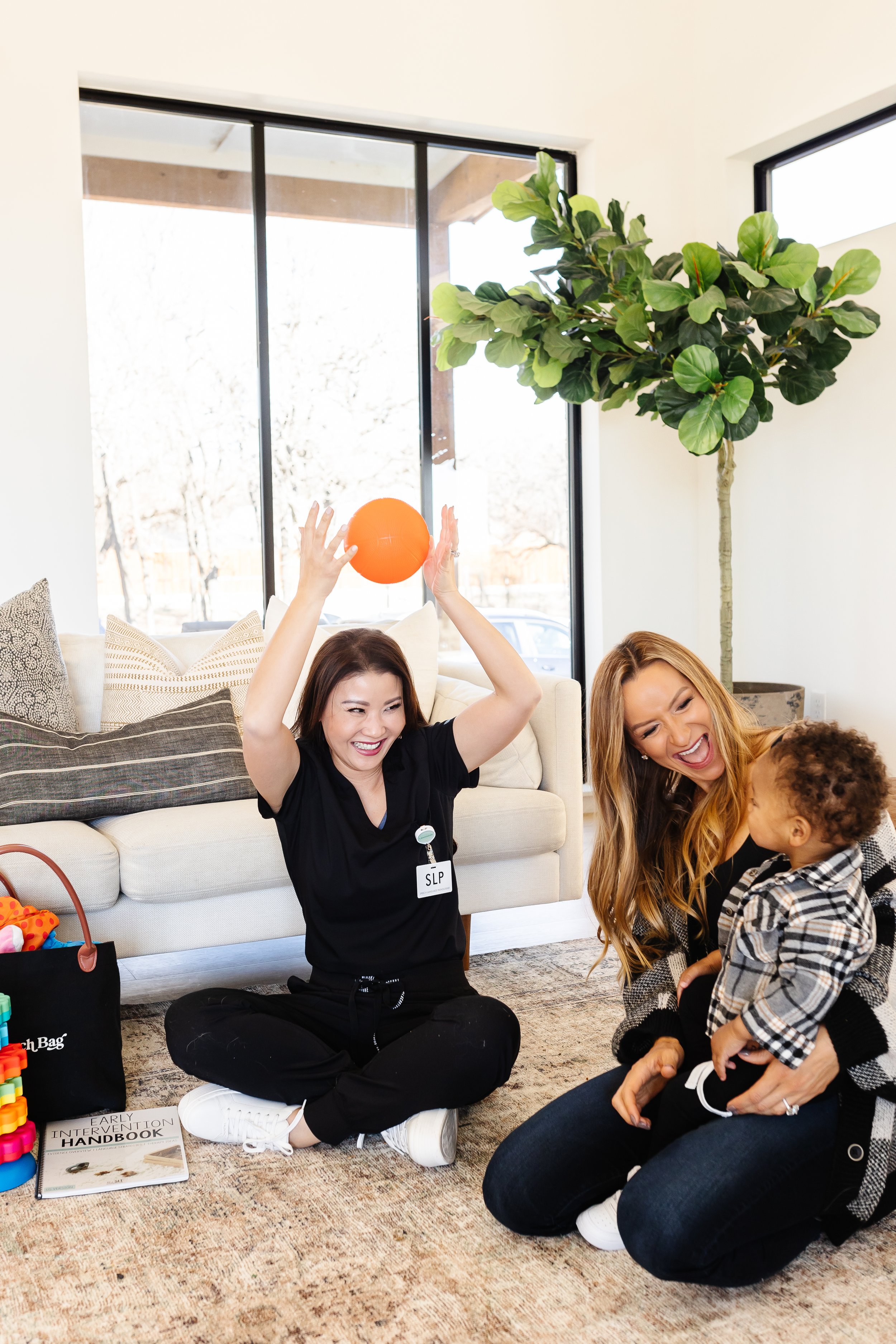 woman playing with a child and their mother