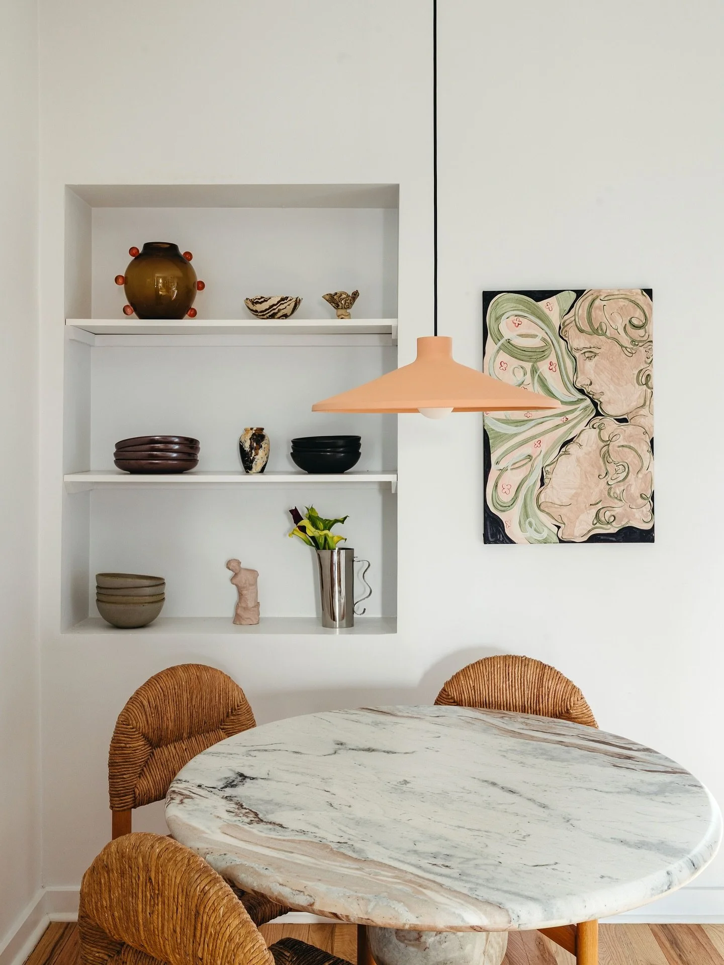 How we carved out a gorg lil dining nook in an open-plan rental (swipe for the befores!)
&nbsp;
1. Swag a pendant. Draped off-center, this clay beauty defines the zone and adds a lil bit of drama
2. A round table helps with flow in a tight space. We 