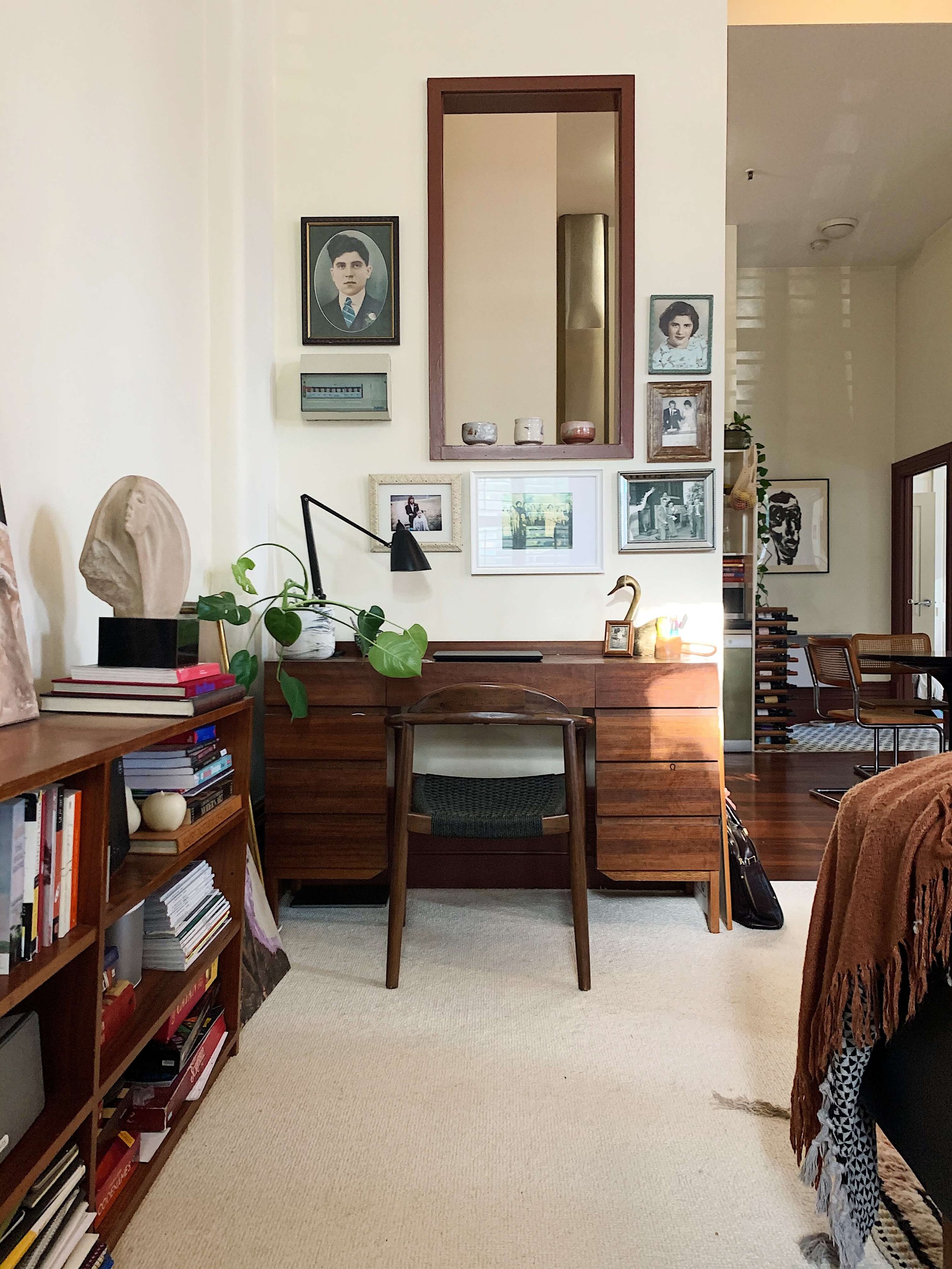Eclectic home office design with a vintage touch, showcasing personalized art and mid-century furniture by Alyssa Owens Design