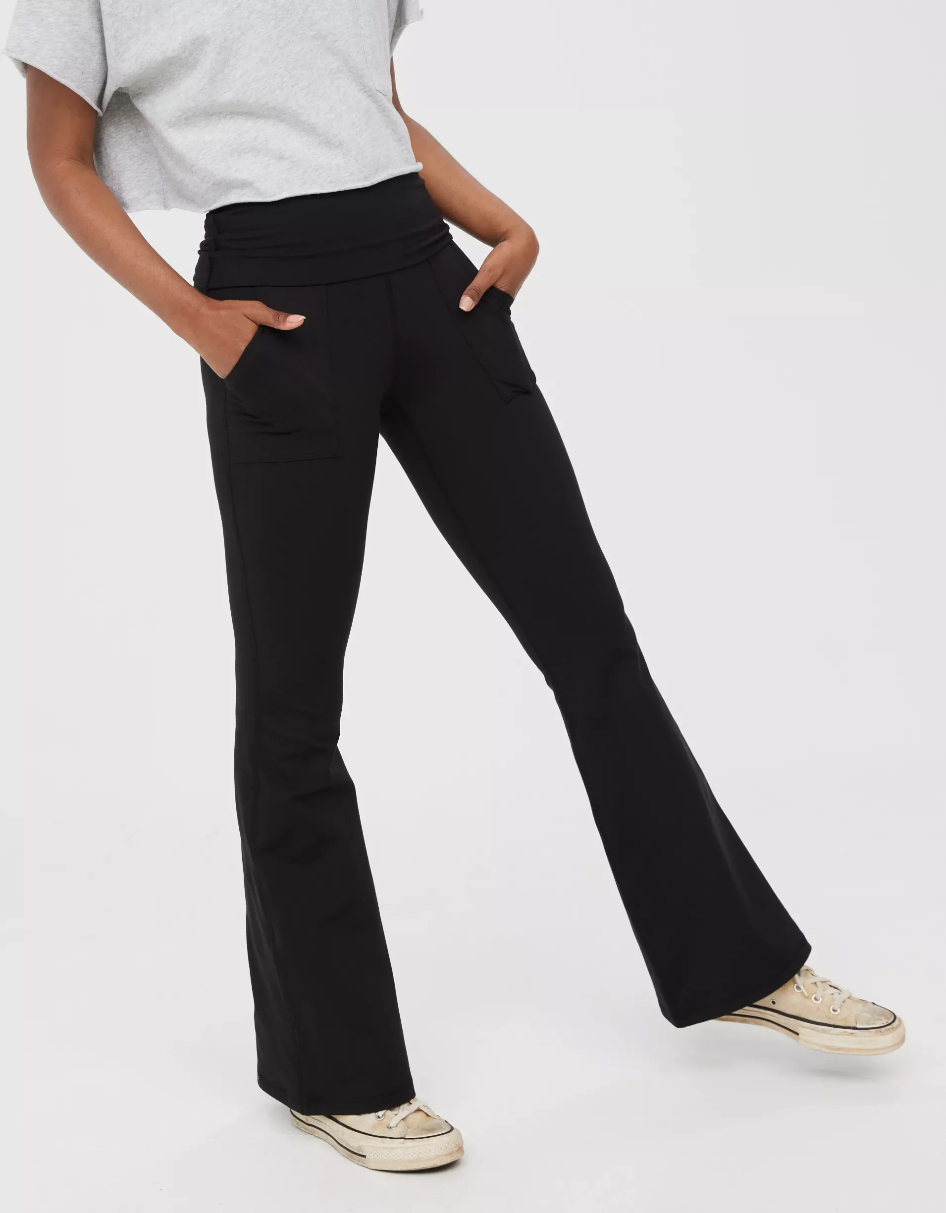 Person wearing black wide-leg pants, a light gray t-shirt, and sneakers.