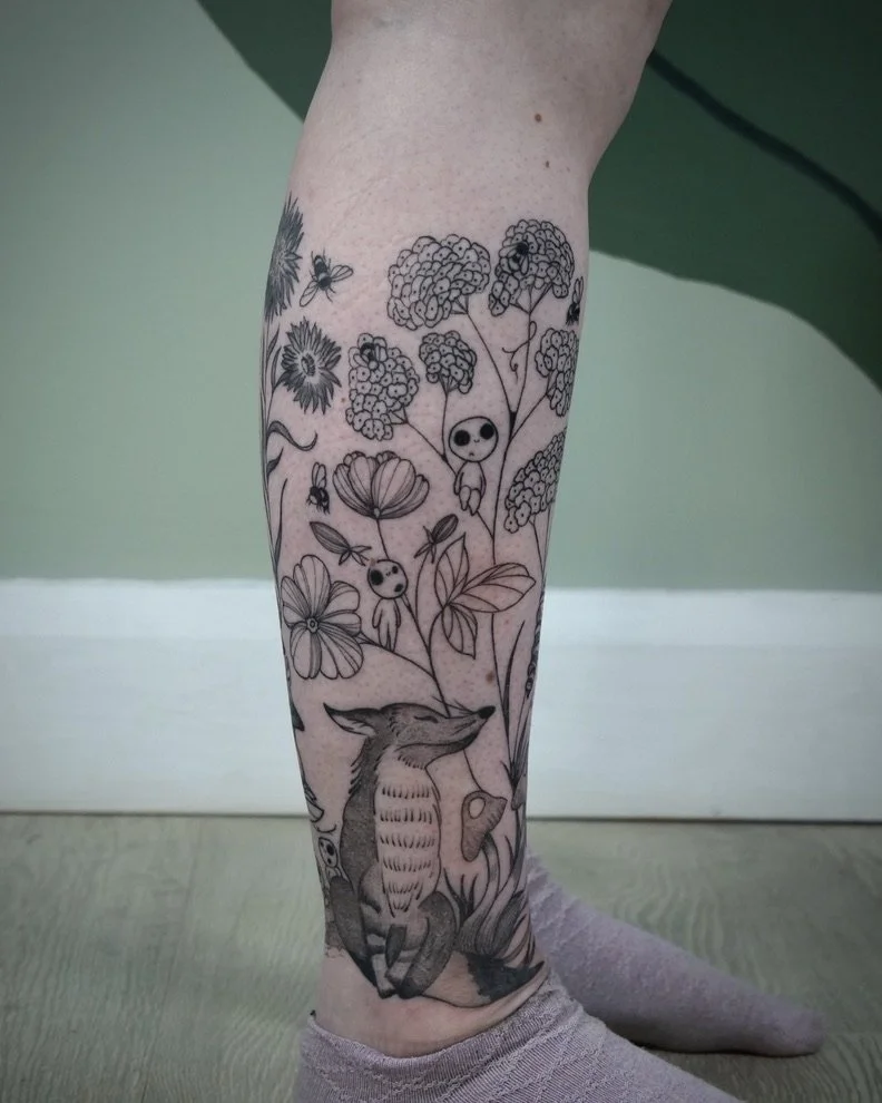 Tattoo of a fox anthropomorphized with a plant growing around it, and cartoonish characters and flowers above.