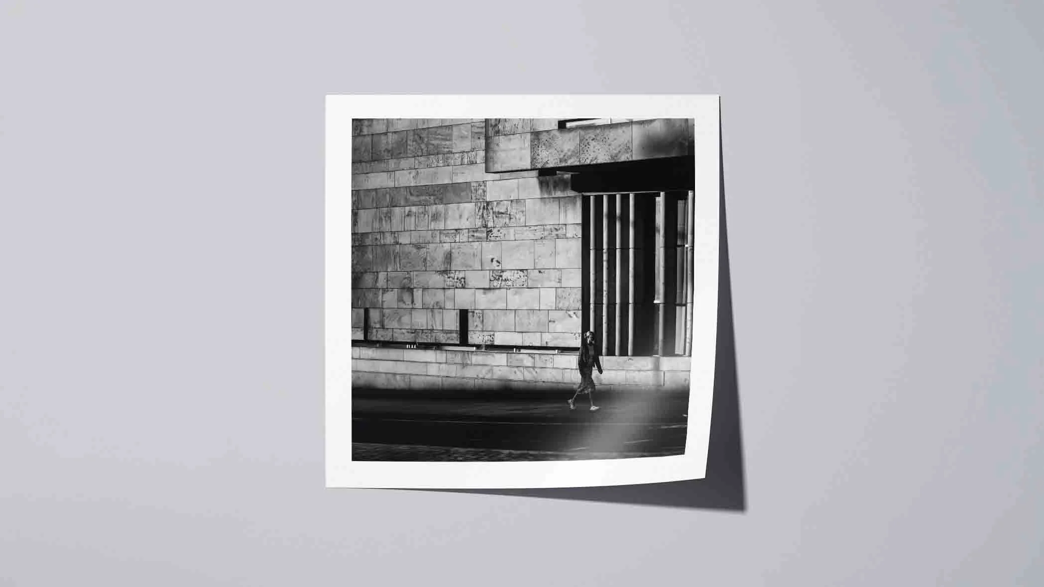 Square format black and white street photography with strong architectural geometry