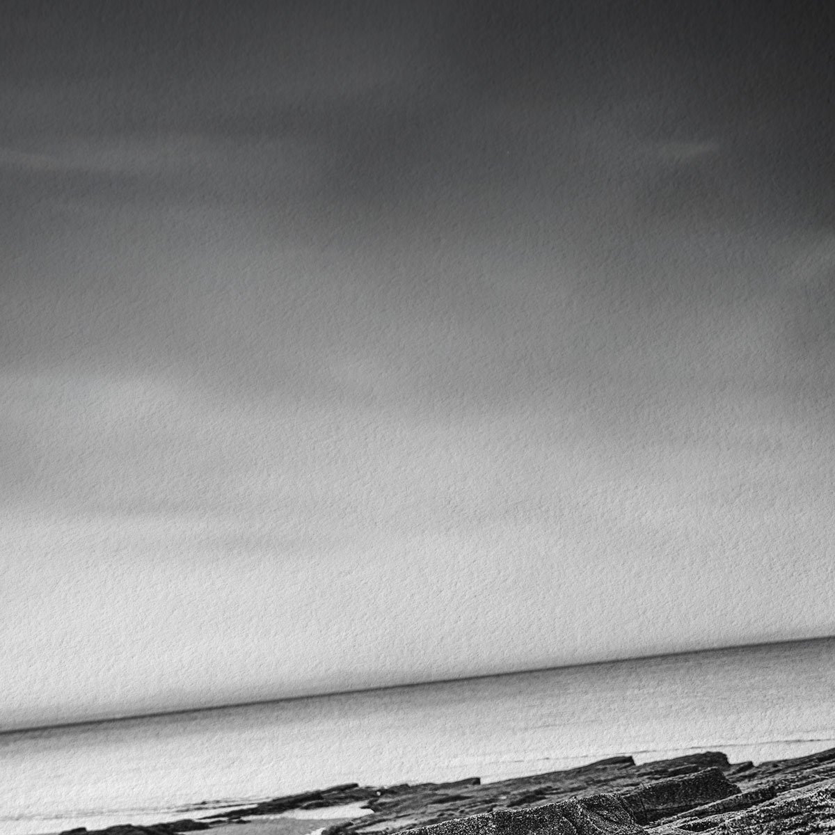 Close-up detail of weathered coastal rock textures in a monochrome fine art photograph.