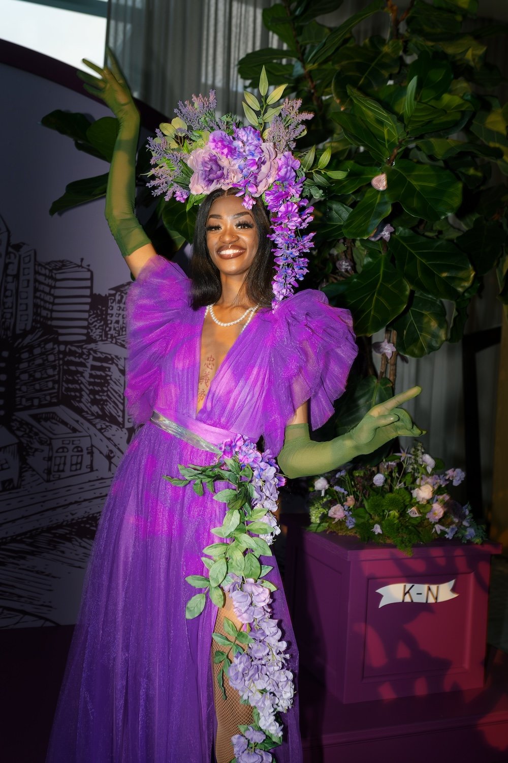 Model in purple dress with floral headdress