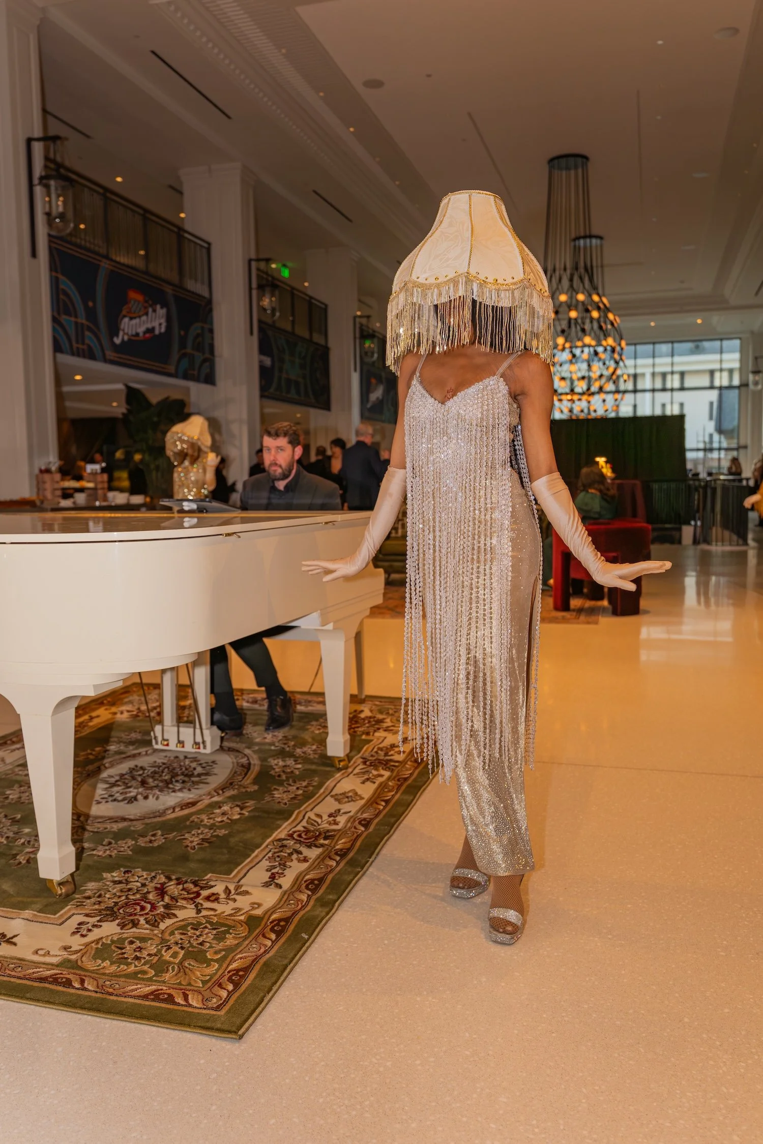 Performer with lampshade on head