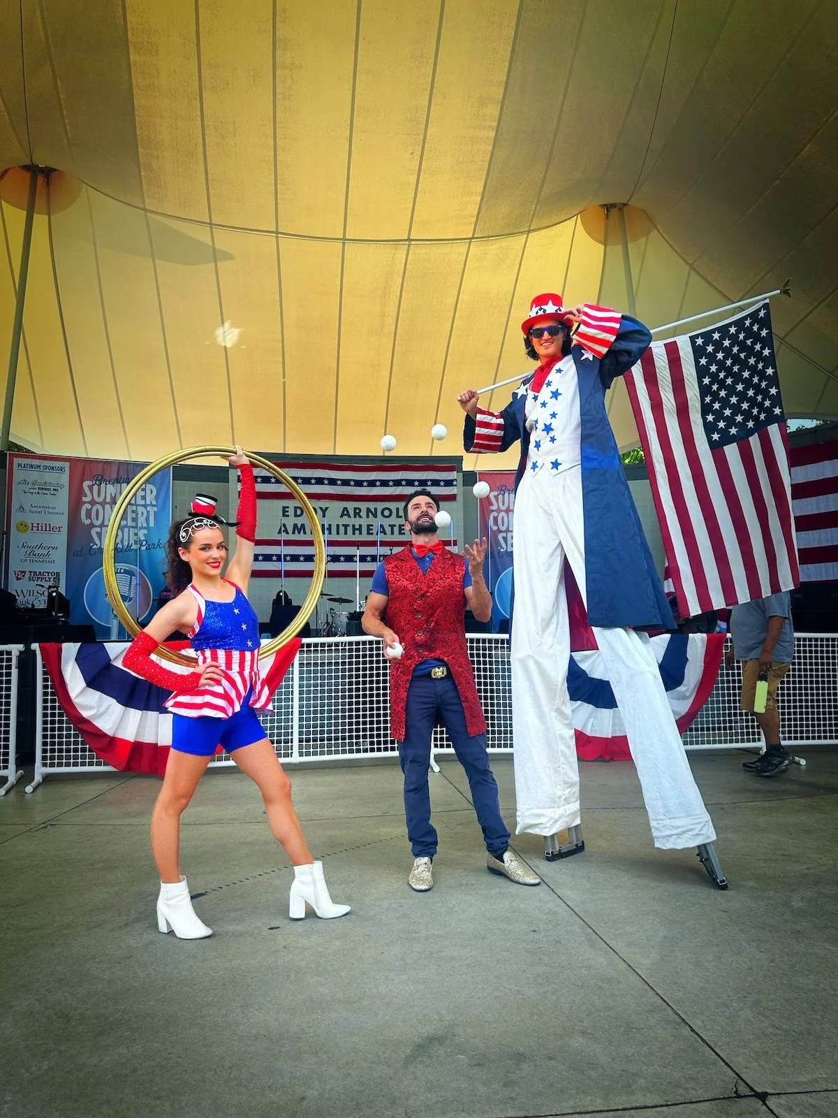 Patriotic stilt walker, professional juggler, and hula hoop performer at the Red, White & BOOM Fourth of July festival in Brentwood.